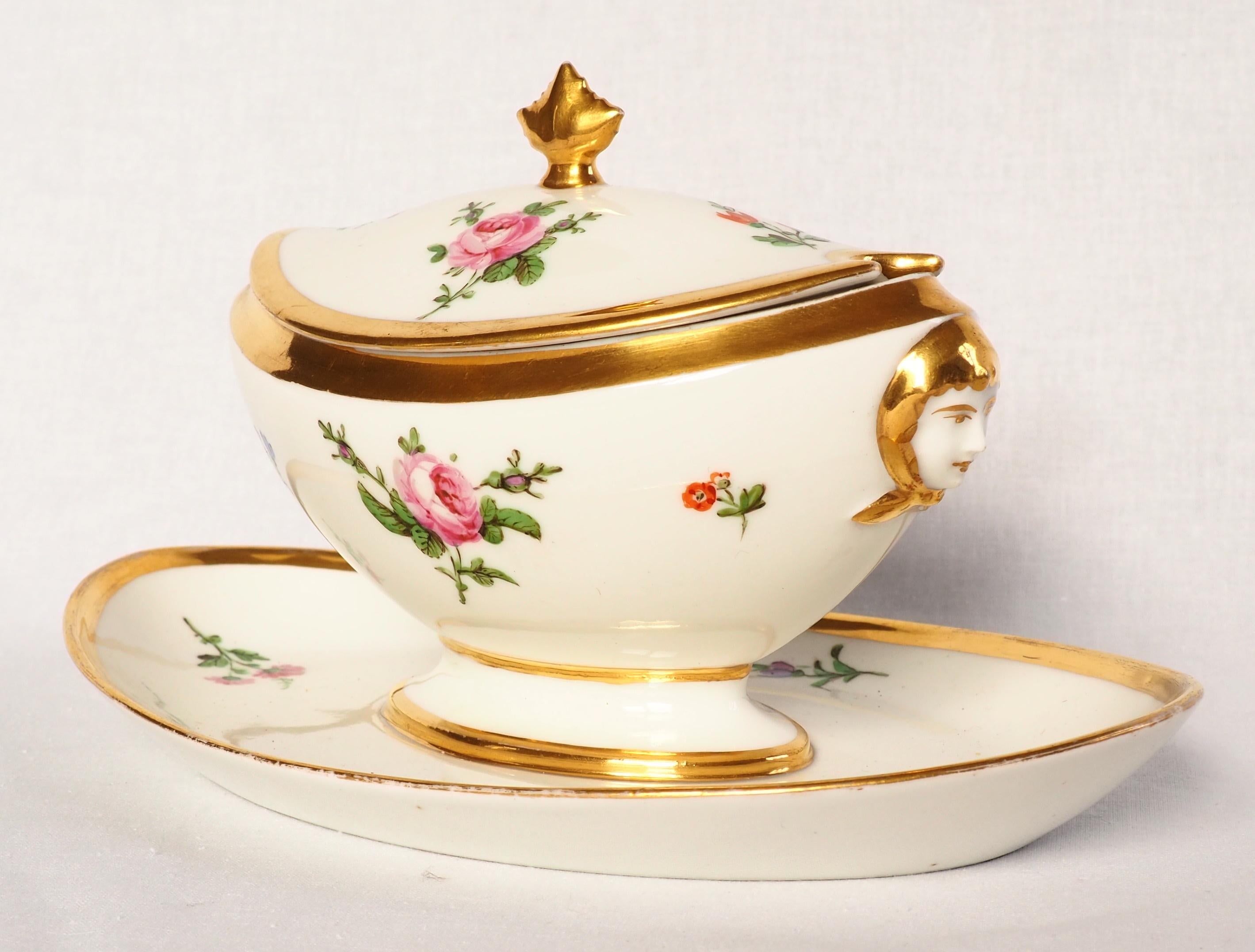 Empire Paris Porcelain sauce boat ; bearutiful 19th century production enhanced with fine gold, decorated with hand-painted polychromatic flowers, antique-style masks on the sides, a palm-shaped handle on top.
Our piece is signed Schoelcher under