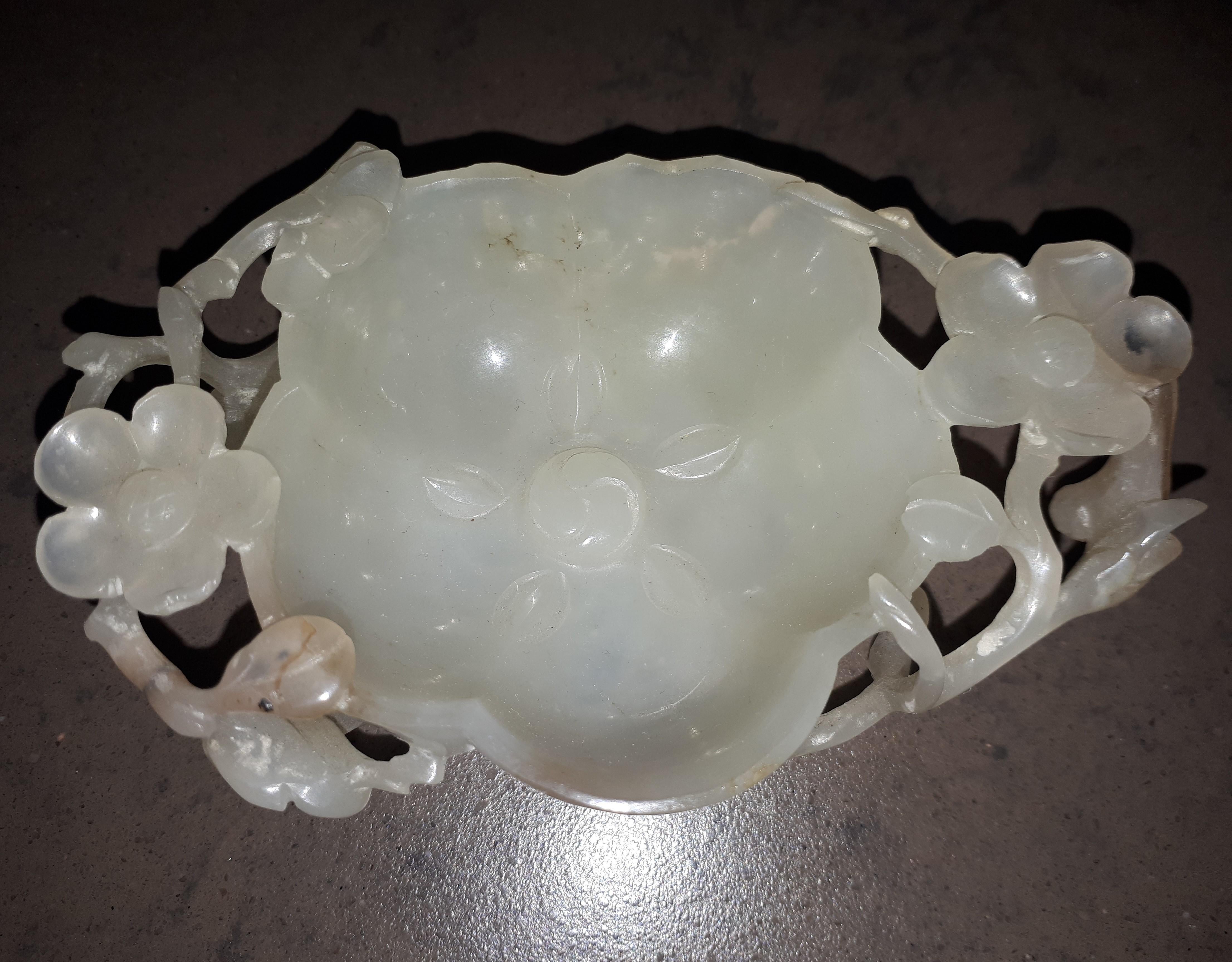 Semi-translucent white jade brush washer carved in the form of a flower surrounded by an intricate openwork network of leafy, gnarled branches bearing various flowers and continuing under the base.
High quality scholar's object.
China, 18th century.