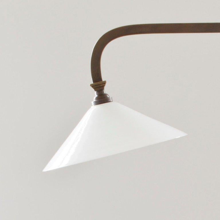 A bronzed effect museum reading lamp with adjustable shades and traditional double sided switches. Â£2,200 not including shades Â£85 per glass coolie shade (+ VAT).
 