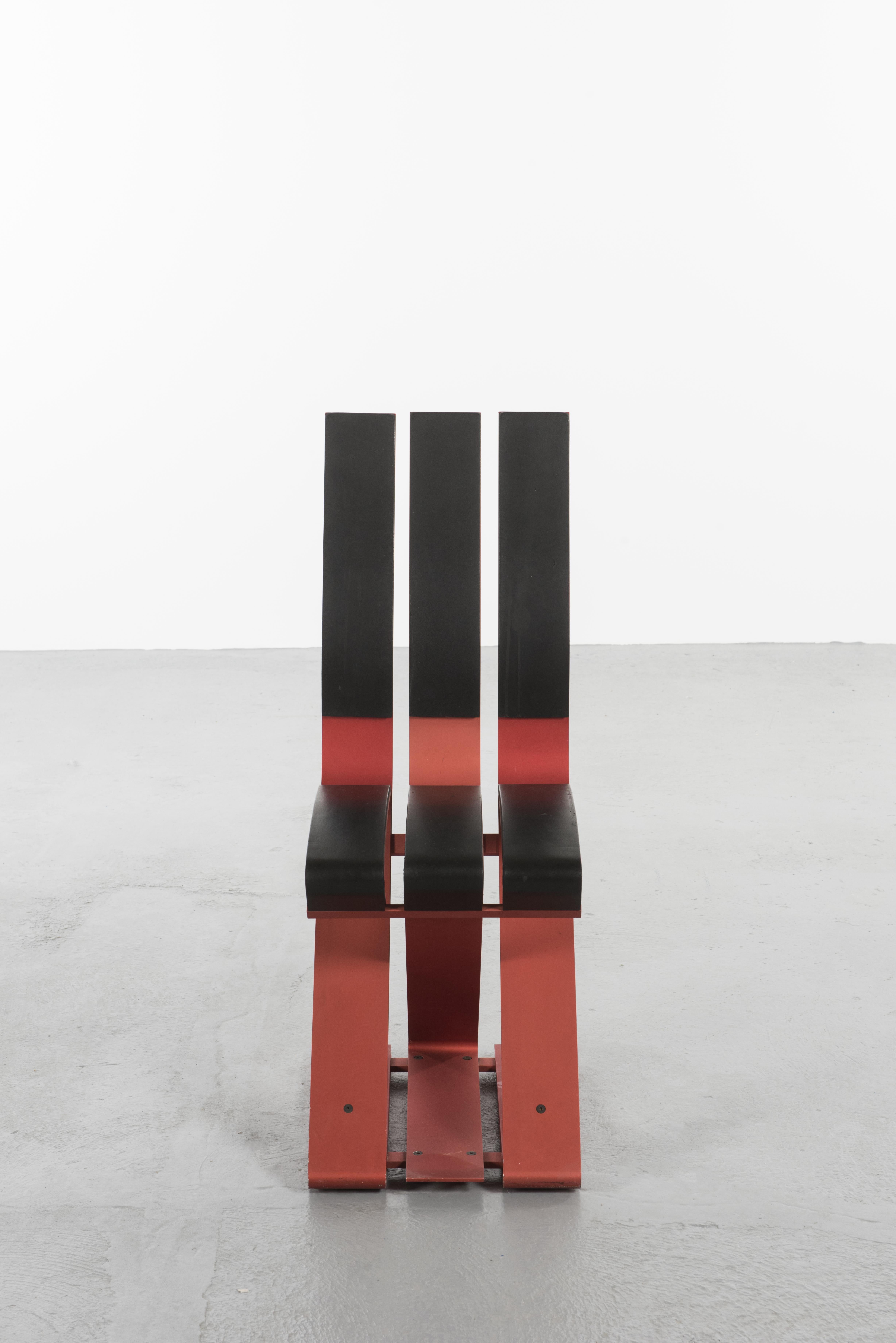School chair by Ron Arad Edited by Vitra, 1988
Enameled aluminum and rubber 
Red aluminum blade structure partially covered with six strips of black neoprene designed by Ron Arad and produced by Vitra

This piece could be a flagship product of the