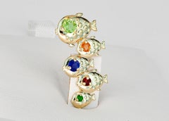 Fish pendant in 14k gold with colored gemstones.