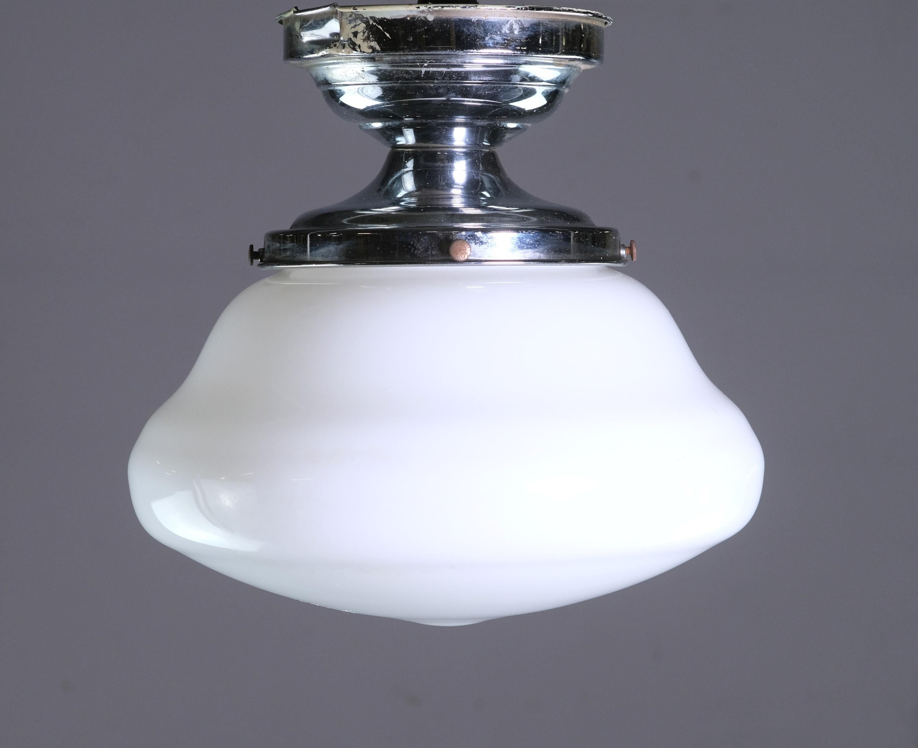 Quantity available. Early 20th century schoolhouse style light. Featuring original white shake with new nickel plated hardware. Semi flush mount design. Cleaned and rewired. Small quantity available at time of posting. Priced each. Please note, this