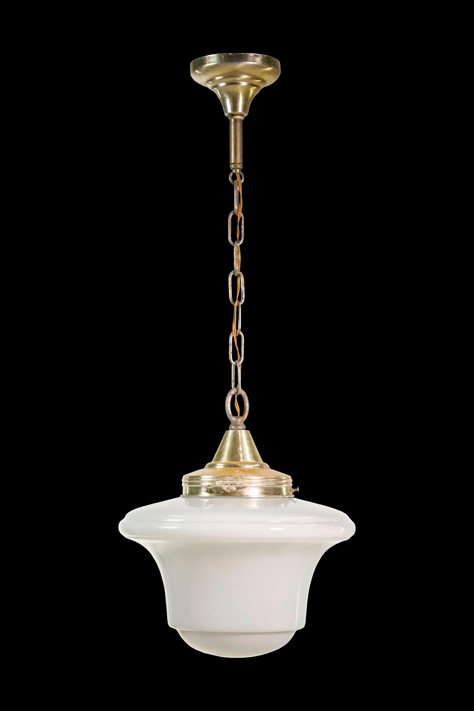 20th century Schoolhouse pendant light featuring a white glass shade and polished brass hardware. Take one standard medium base lightbulb. Cleaned and restored. Please note, this item is located in one of our NYC locations.