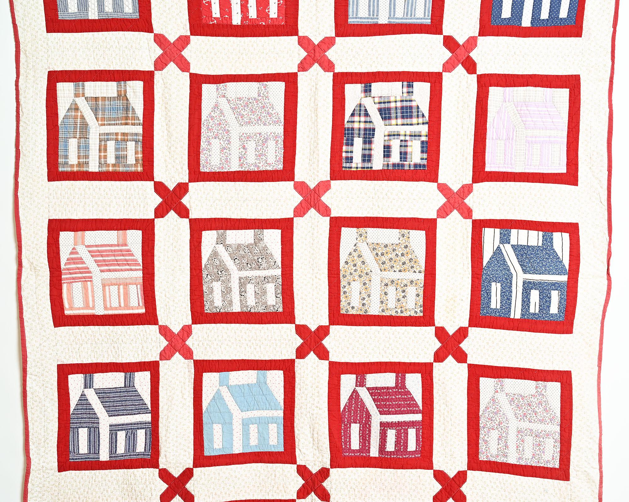 Schoolhouse is one of the most iconic of American quilt patterns. This lovely example has each Schoolhouse set in a vivid red frame with x's at the intersections between the blocks. Each building is a different fabric, most of which are prints. The