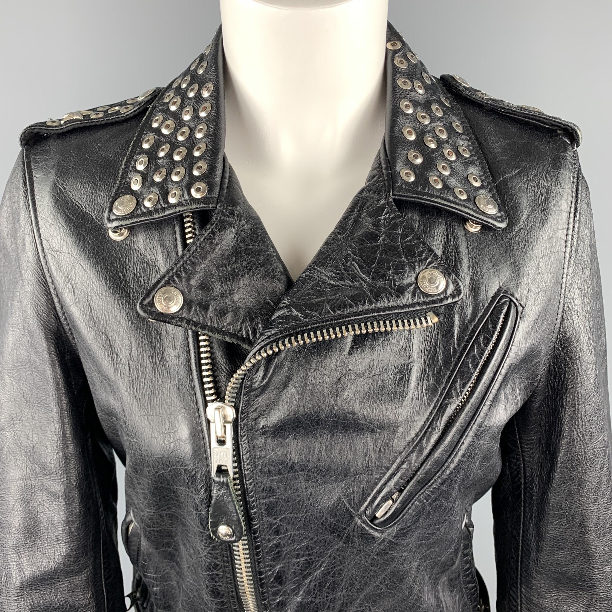 This limited edition SCHOTT biker jacket comes in textured black leather with a zip front, slanted zip pockets, half belt waist, studded lapel, star studded epaulets. and lacy up studded zip cuffs. Made in USA.

Very Good Pre-Owned