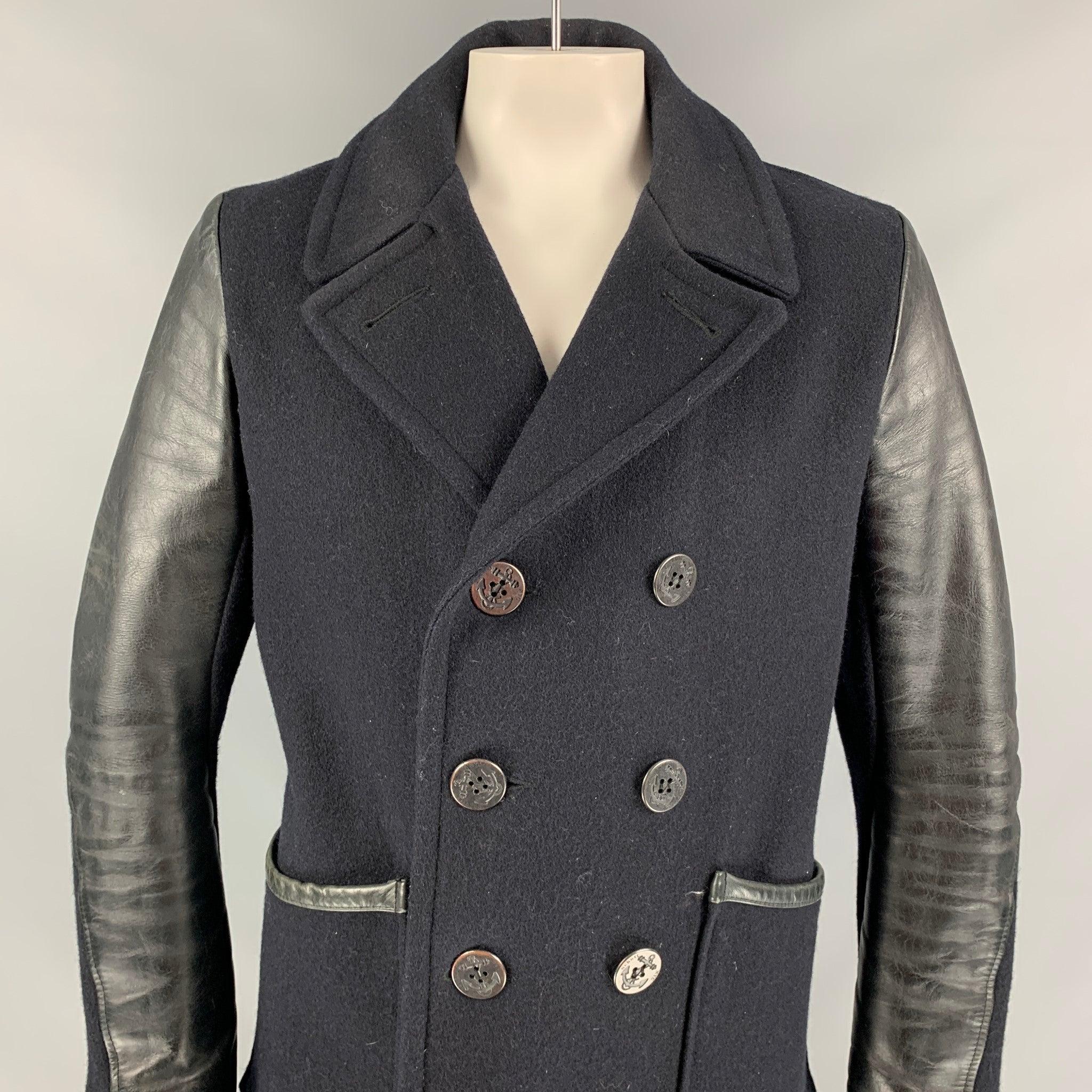 SCHOTT pea coat comes in a black material with a full liner featuring leather sleeves, patch pockets, and a double breasted closure. Made in Canada.
Good
Pre-Owned Condition.  

Marked:   L 

Measurements: 
 
Shoulder: 18.5 inches  Chest: 44 inches 