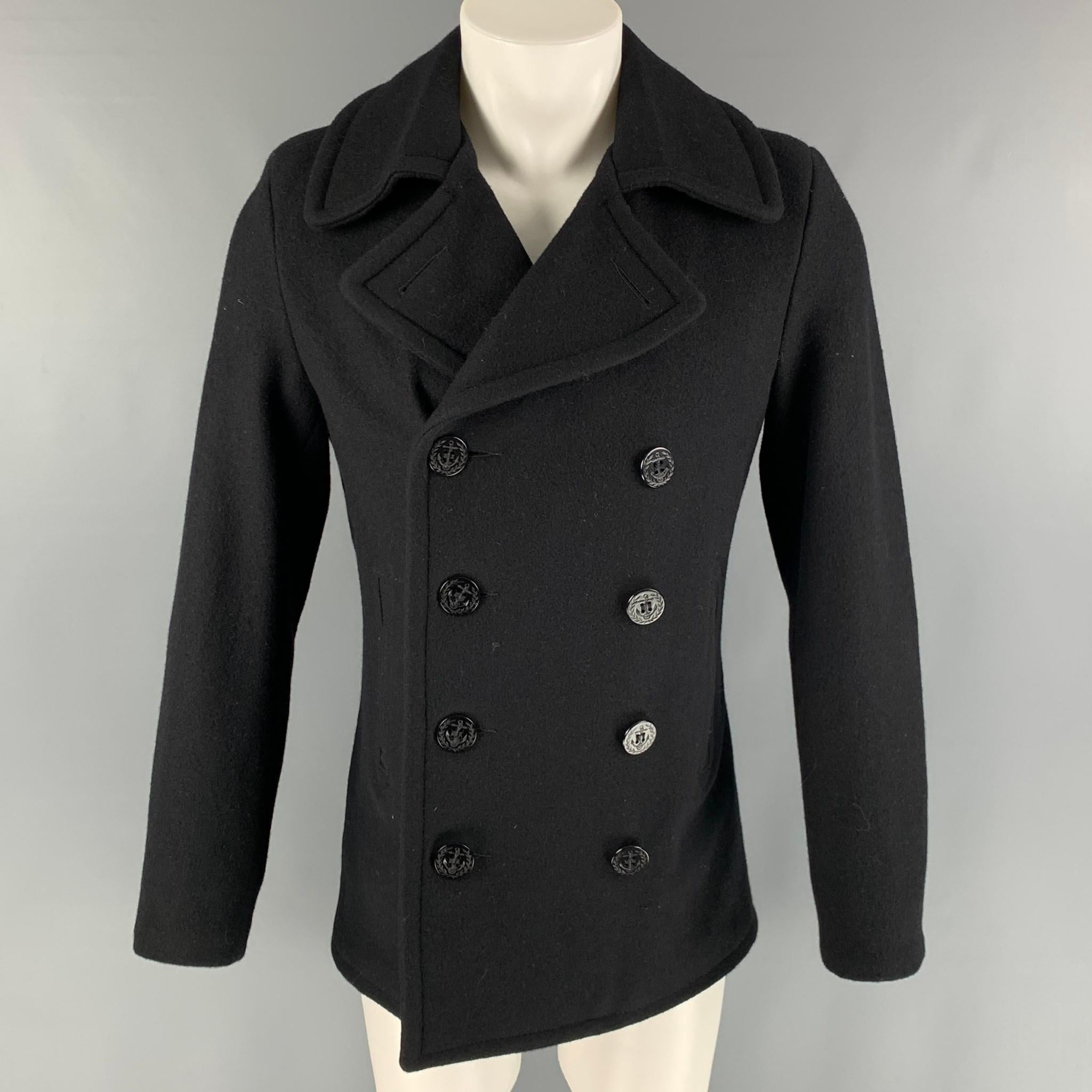 SCHOTT coat comes in a black wool and nylon material featuring a slim fit, large lapel, slit pockets, and a double breasted closure. Made in USA.

Very Good Pre-Owned Condition.
Marked: M

Measurements:

Shoulder: 17 in.
Chest: 38 in.
Sleeve: 26