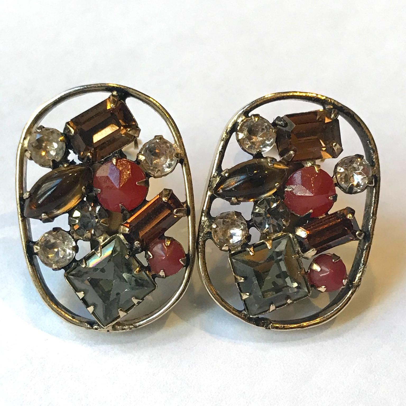 A wonderful pair of 1950s Henry Schreiner shadow box design clip earrings. The shadow box refers to the wide flat metal boarder around the earrings. It was design devised by Ambrose Albert, the son-in-law of Henry Schreiner. It was used on brooches,