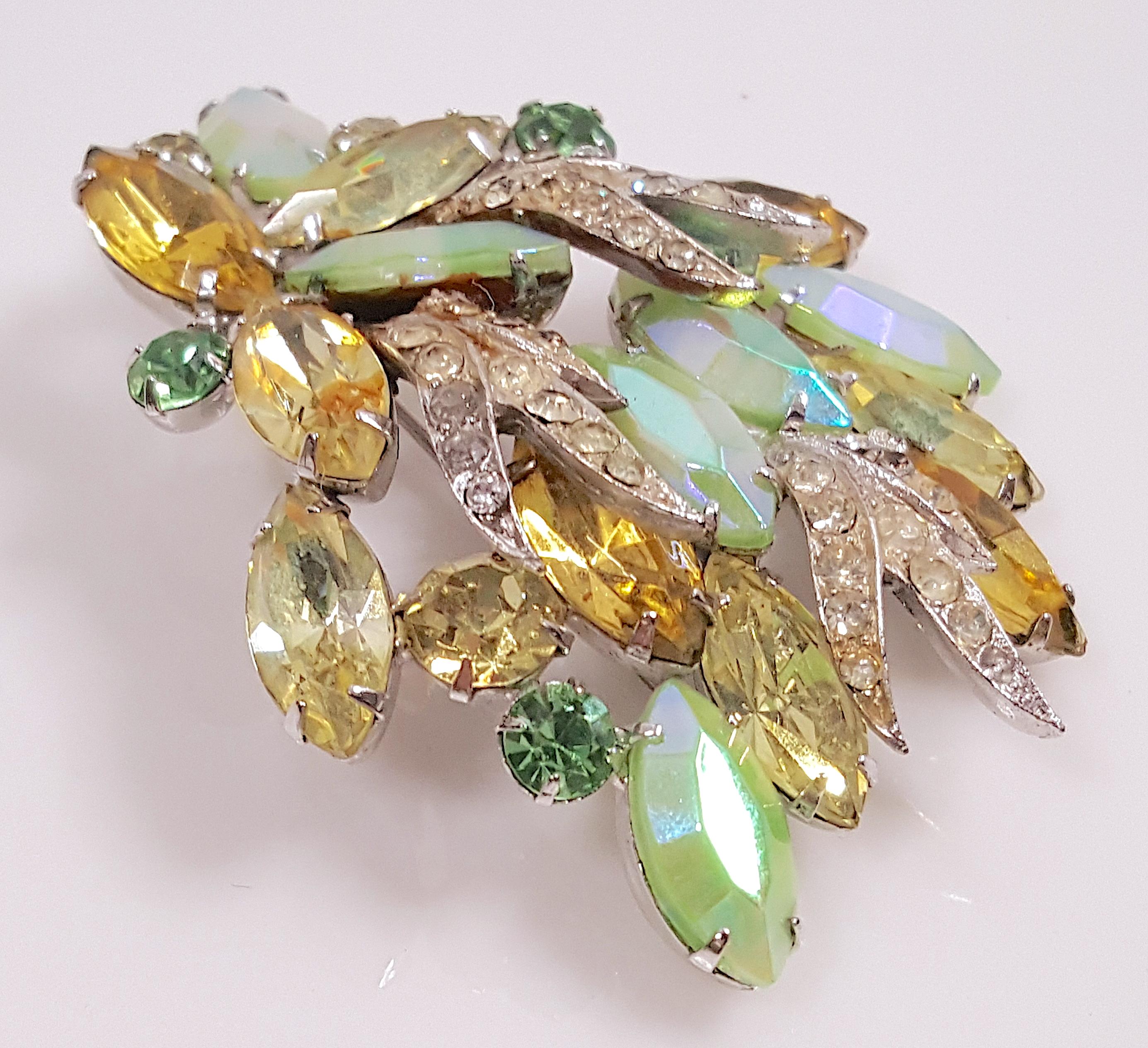 This colorful prong-set crystal spray brooch by Schreiner New York was made to compliment luxury clothing by a U.S.-based fashion designer, such as Pauline Trigere, in the late 1950s. This piece is special because it shows the unique decorative