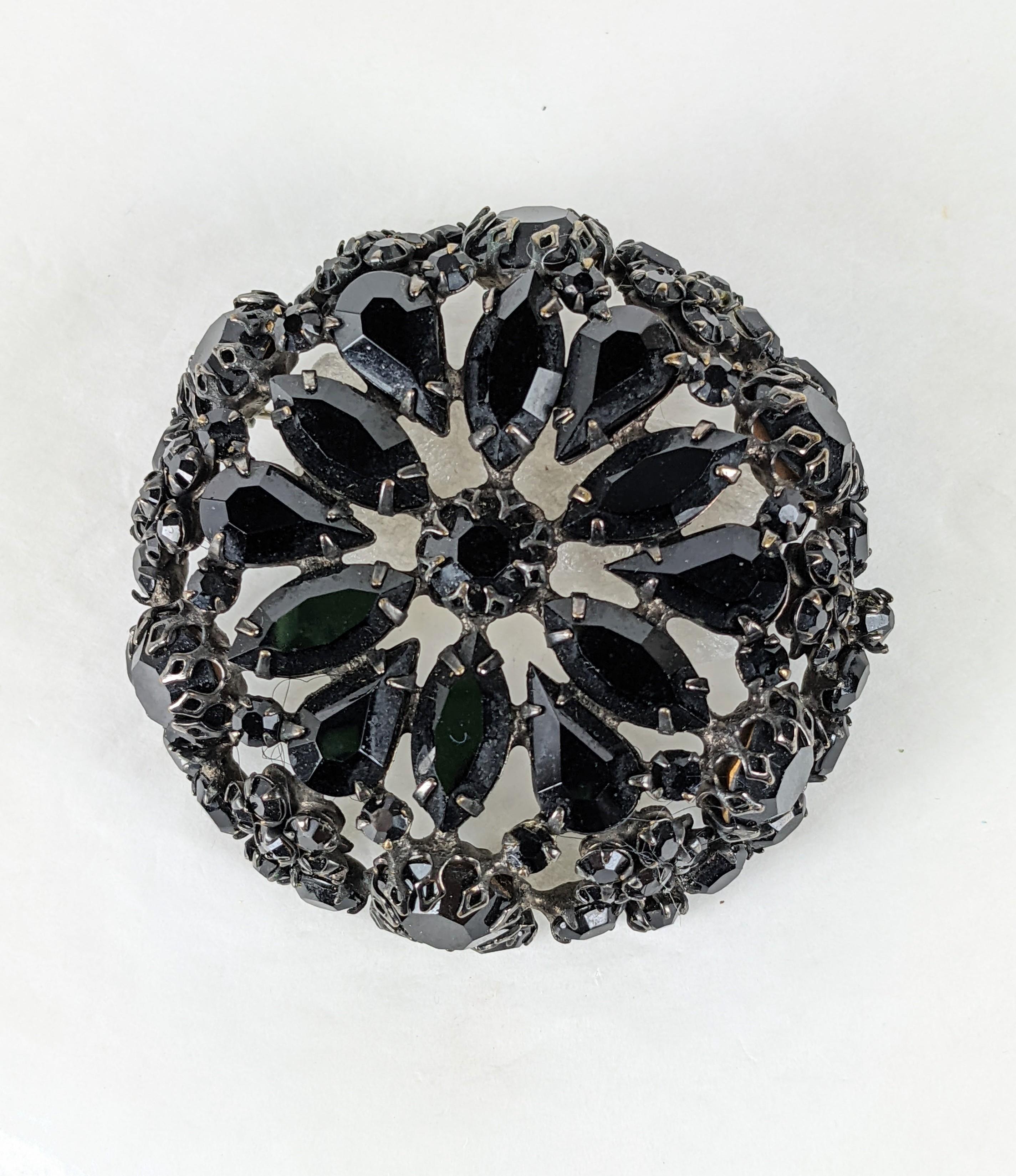 Schreiner Jet Crystal Round Brooch with elaborate construction and stone cuts of ovals, pears, marquises and rounds on a 3D base. Japanned metal finish. Pendant hook on back as well. 
Signed. 2.35