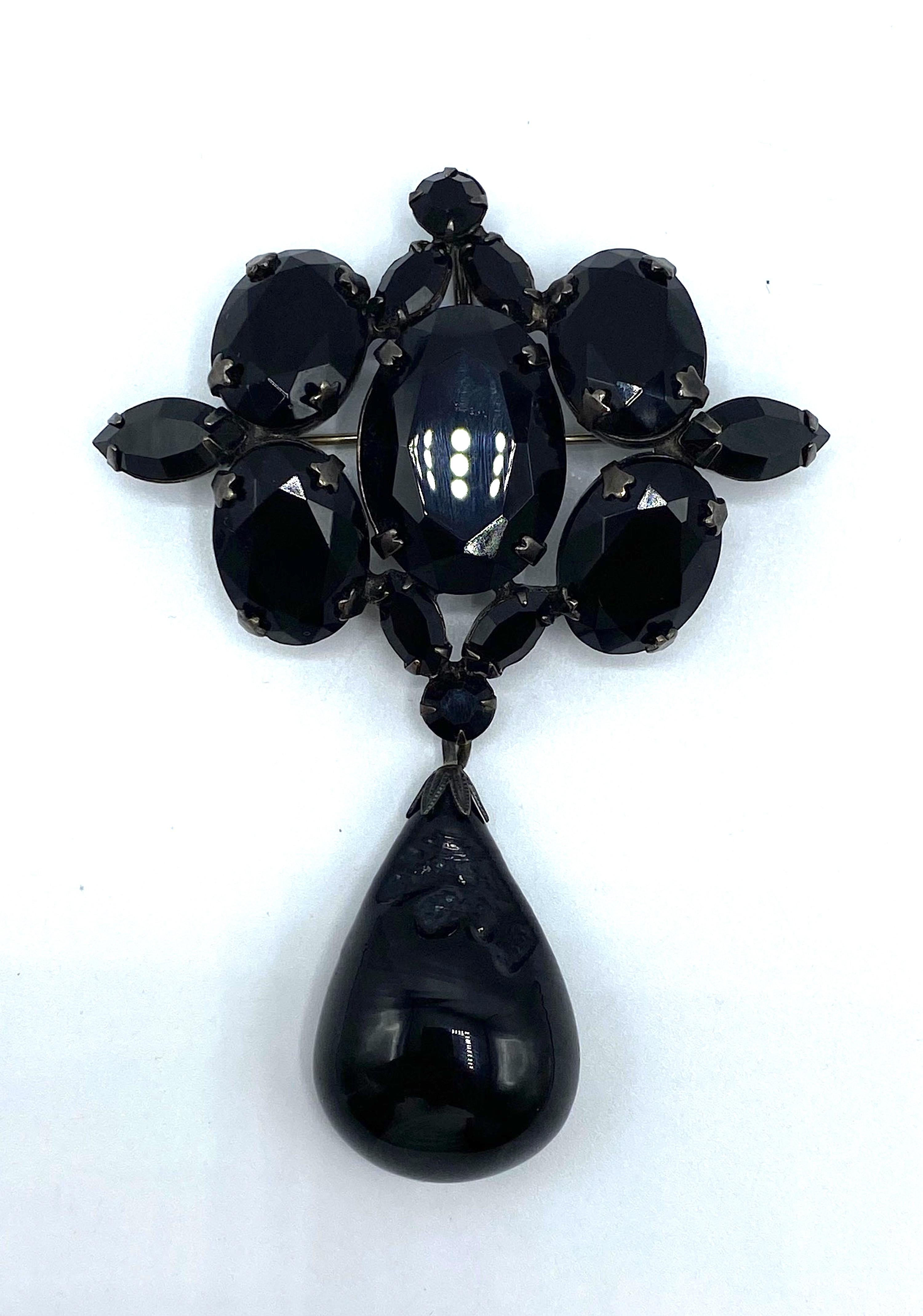 A unique and special signed Schreiner New York all black crystal and glass brooch. The charcoal gun metal grey brooch is set with five large oval, two small round and six marquise shape black cut crystal stones. Additionally, there is a large hand