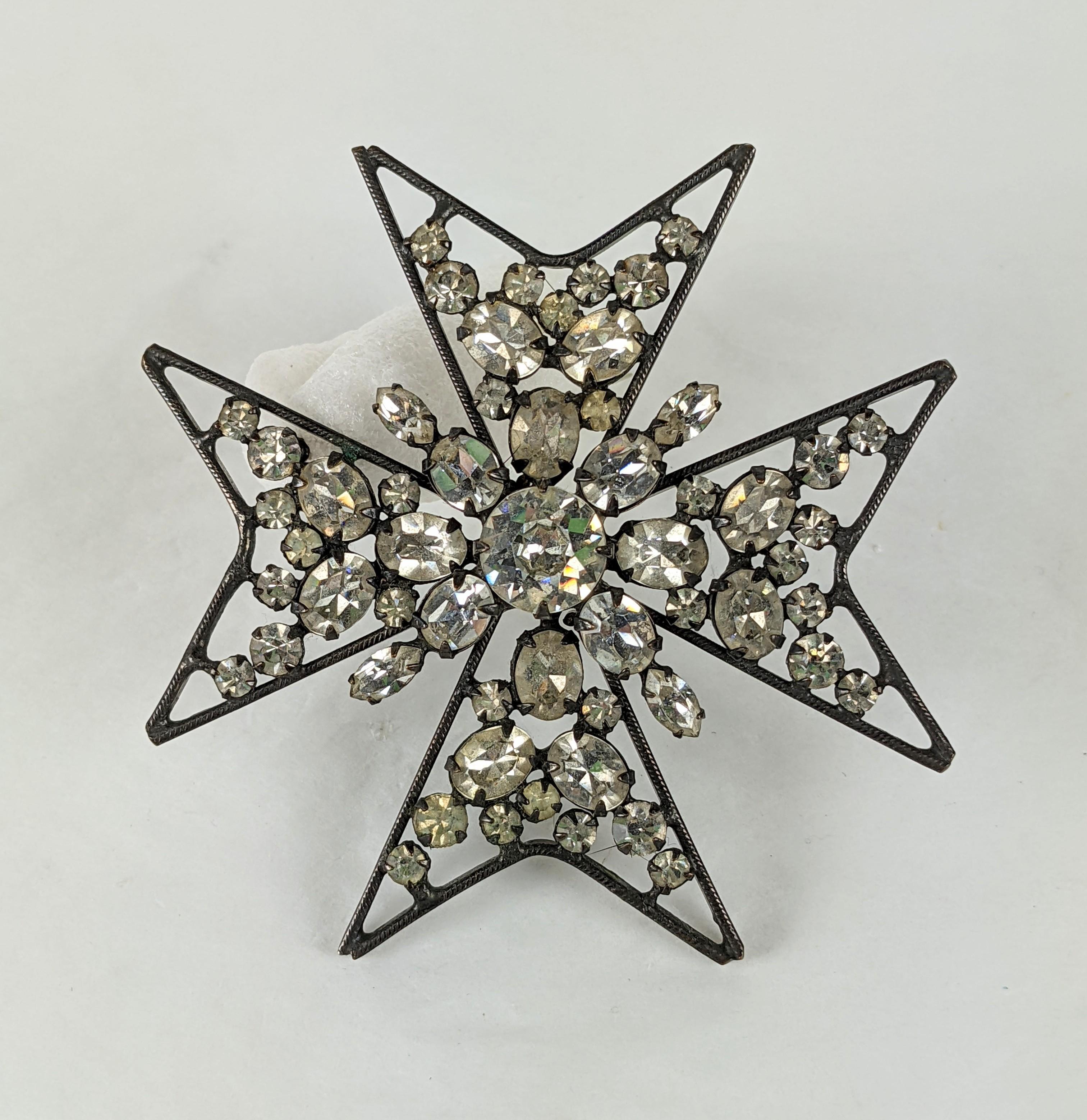 Schreiner DD Ryan owned Iron or Maltese style Cross brooch.  Featuring a raised center cluster of  varied crystal stones including marquise ovals and rounds in an openwork setting in japanned blackened metal. Former collection of DD Ryan Fashion