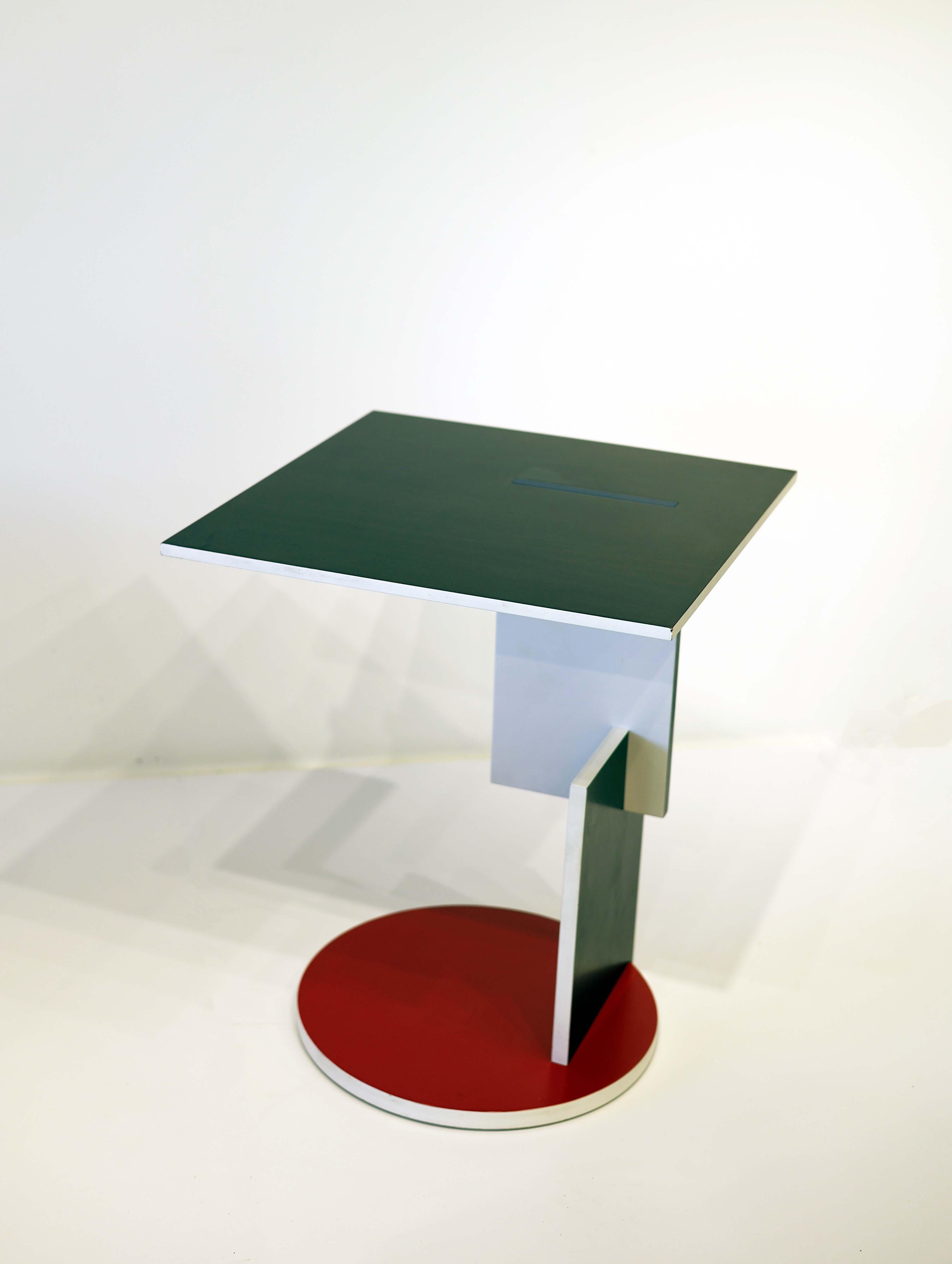 Wooden low table with top in beechwood black finish and red, white, blue and yellow lacquered parts.