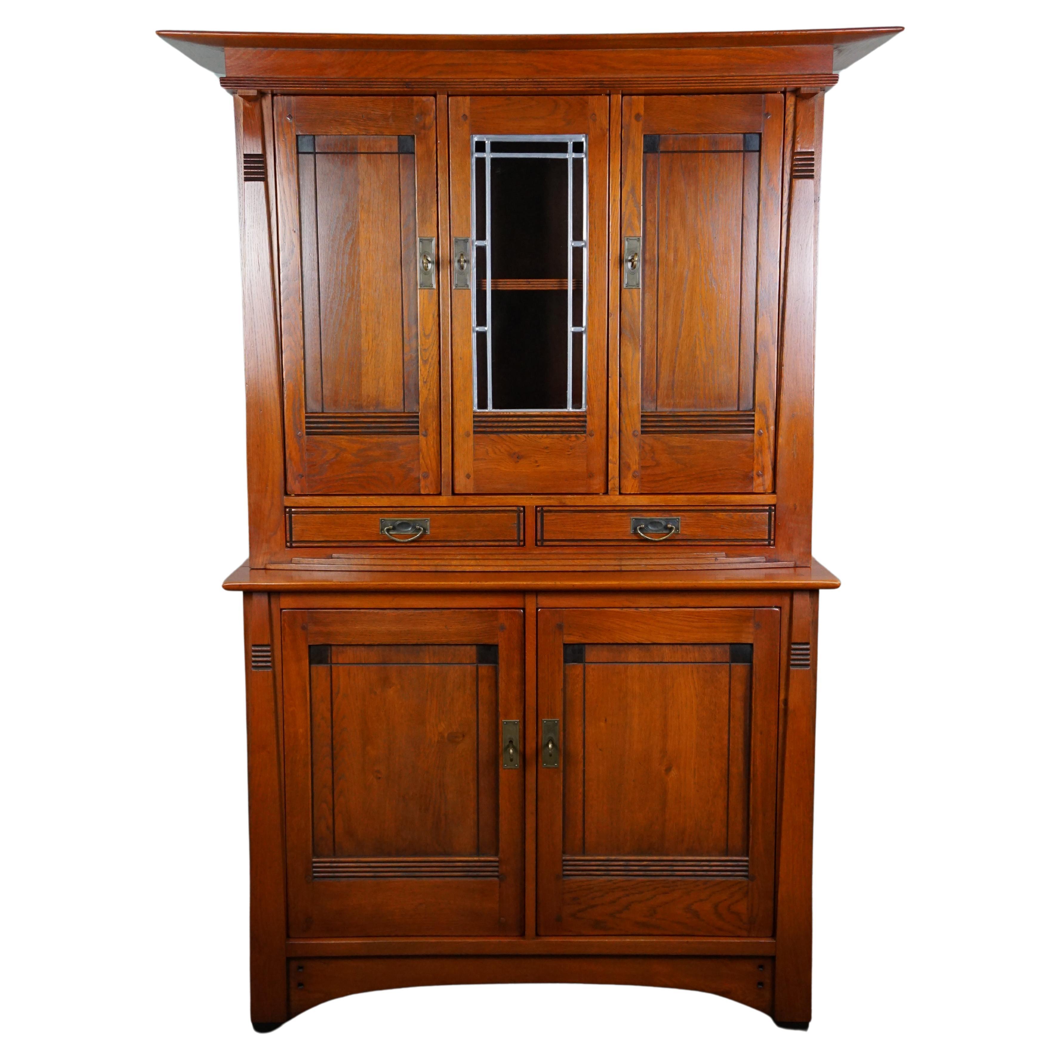 Schuitema Art Nouveau buffet cabinet with stained glass in good condition For Sale