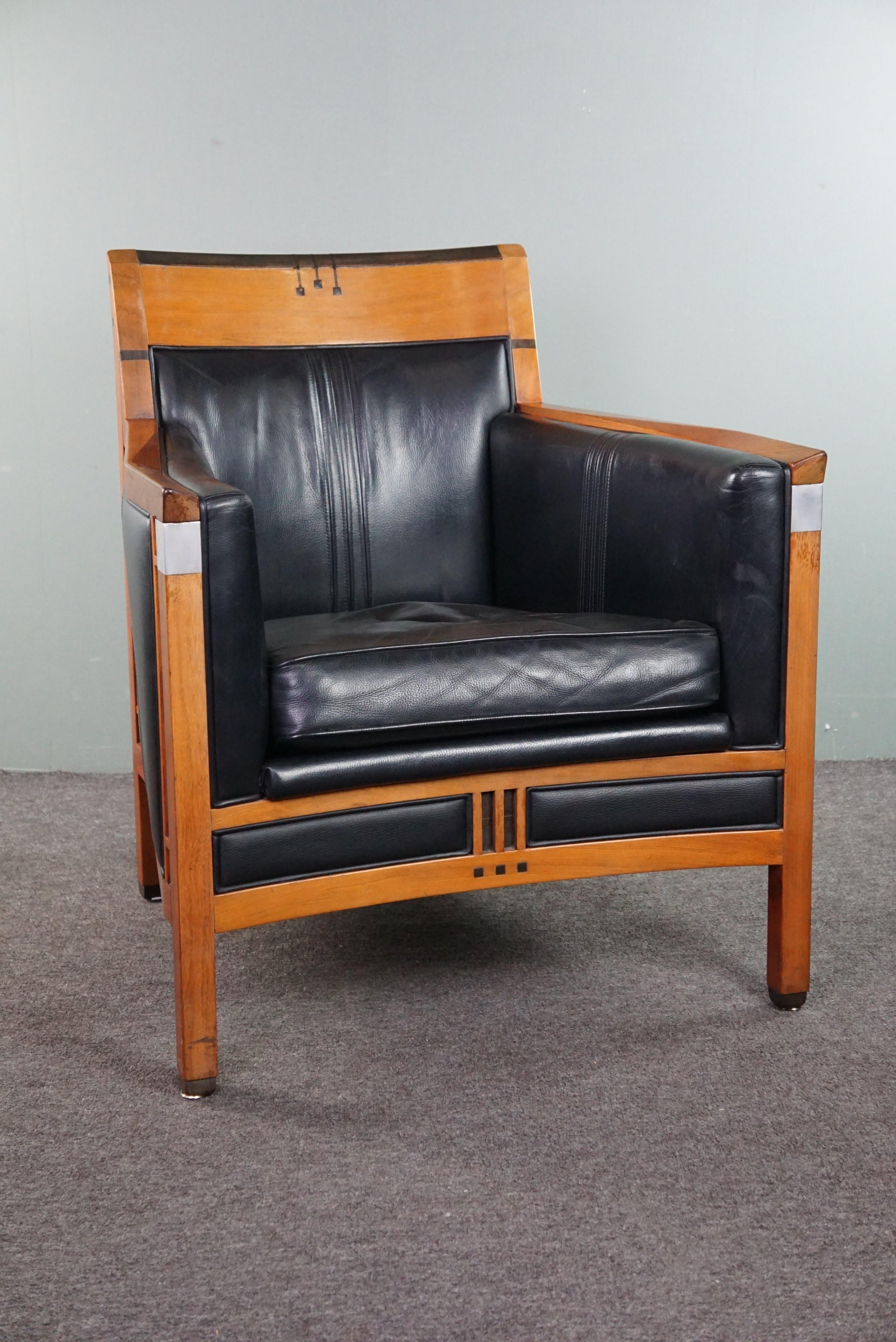 Offered: this fantastic Schuitema Decoforma Art Deco design armchair with black leather and beautiful accents.

A piece of furniture designed and crafted by Schuitema equals stunning design and very high quality, just like this beautiful design