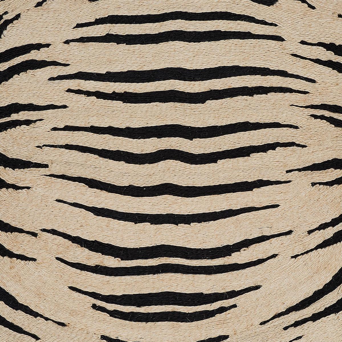 Designed by Adam Charlap Hyman and inspired by 17th-century cabinets of curiosity, Tigre is a fanciful, uniquely modern take on a tiger trophy rug. Featuring black and natural-colored stripes formed from hand-coiled abaca, this rug defines animal