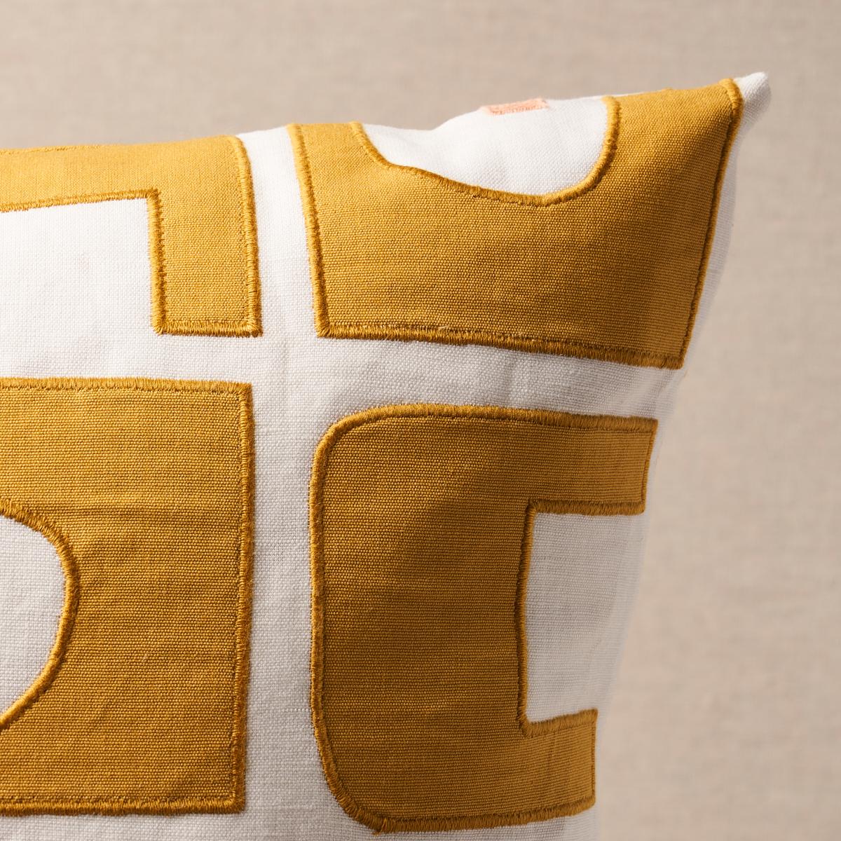 This pillow features Den Applique by Hadiya Williams for Schumacher with a knife edge finish. Hadiya Williams’ Den Appliqué in ochre is a wonderfully imaginative irregular-grid pattern based on paper cutouts. Abstracted architectural shapes are
