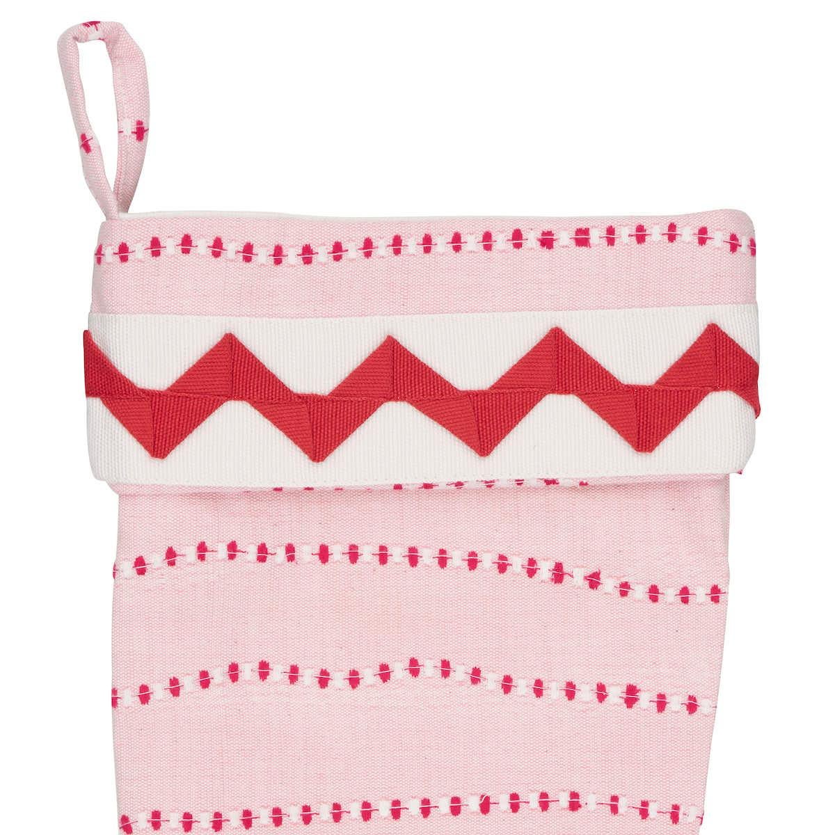 *Pre-order, available to ship in October.

The playful pink and red wavy lines of Schumacher’s Elodie Embroidery fill this limited-edition holiday stocking with candy-colored joy. The fabric’s unique rhythmic stripes intersect with a vibrant