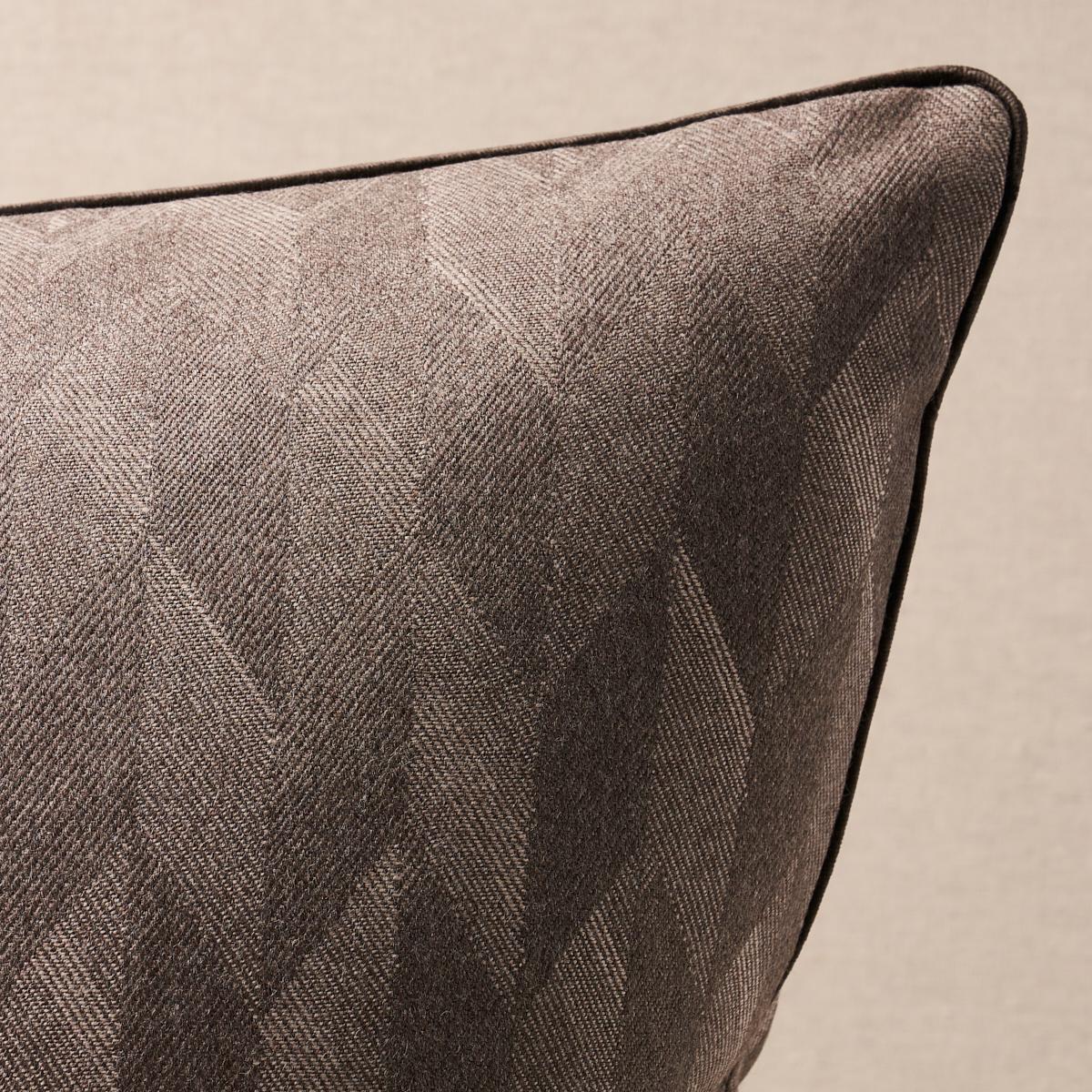 This pillow features Ezra Wool. A soft, textural weave, Ezra Wool in basalt features a subtle allover chevron pattern with a sophisticated tailored aesthetic. Pillow is finished with a welt in Sophia Velvet fabric. Welt content: 39% modal viscose,