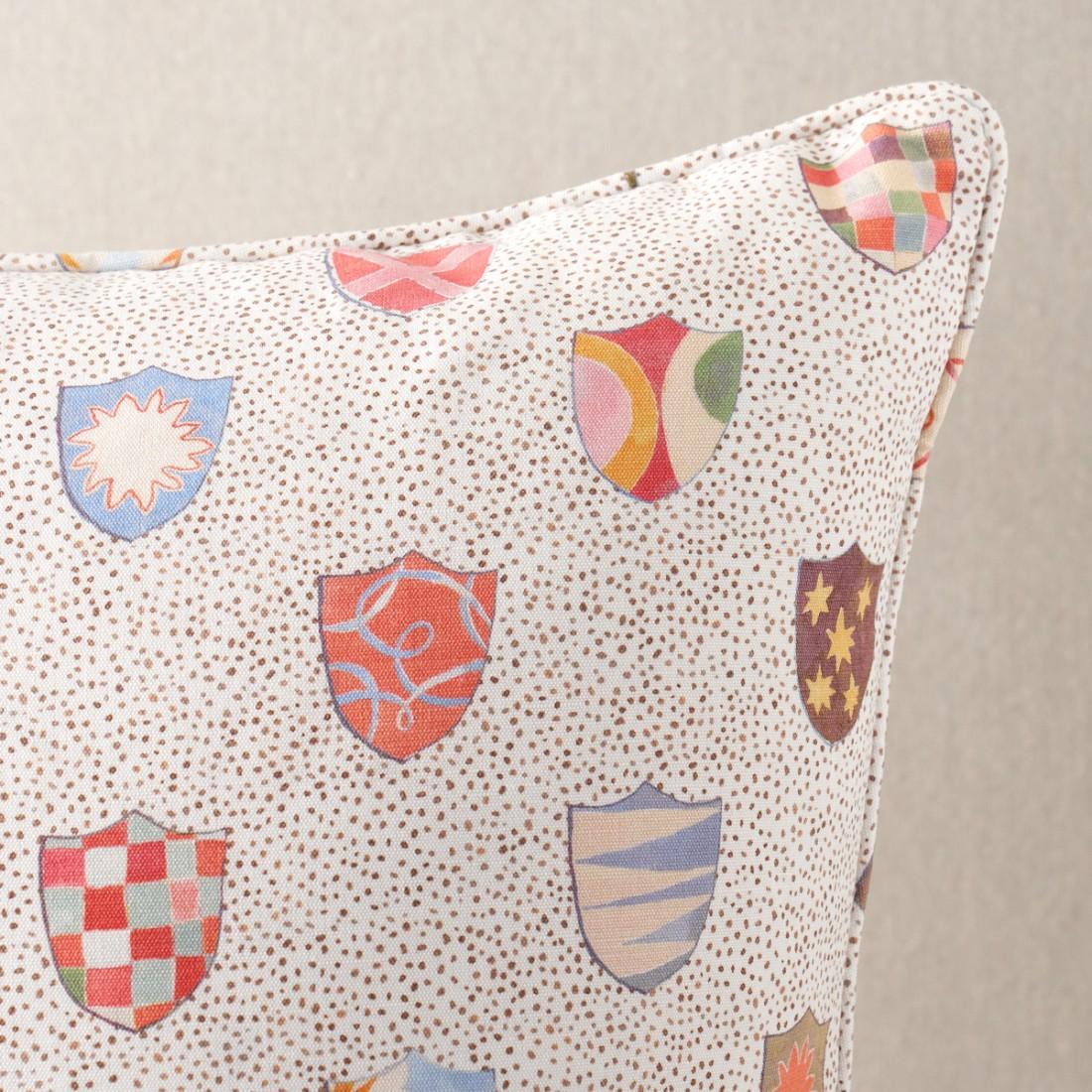 This pillow features Heraldic by Happy Menocal for Schumacher with a self-welt finish. A delightful small-scale print by Happy Menocal, Heraldic breathes new life and levity into an ancient aristocratic motif. Colorful shields featuring whimsical