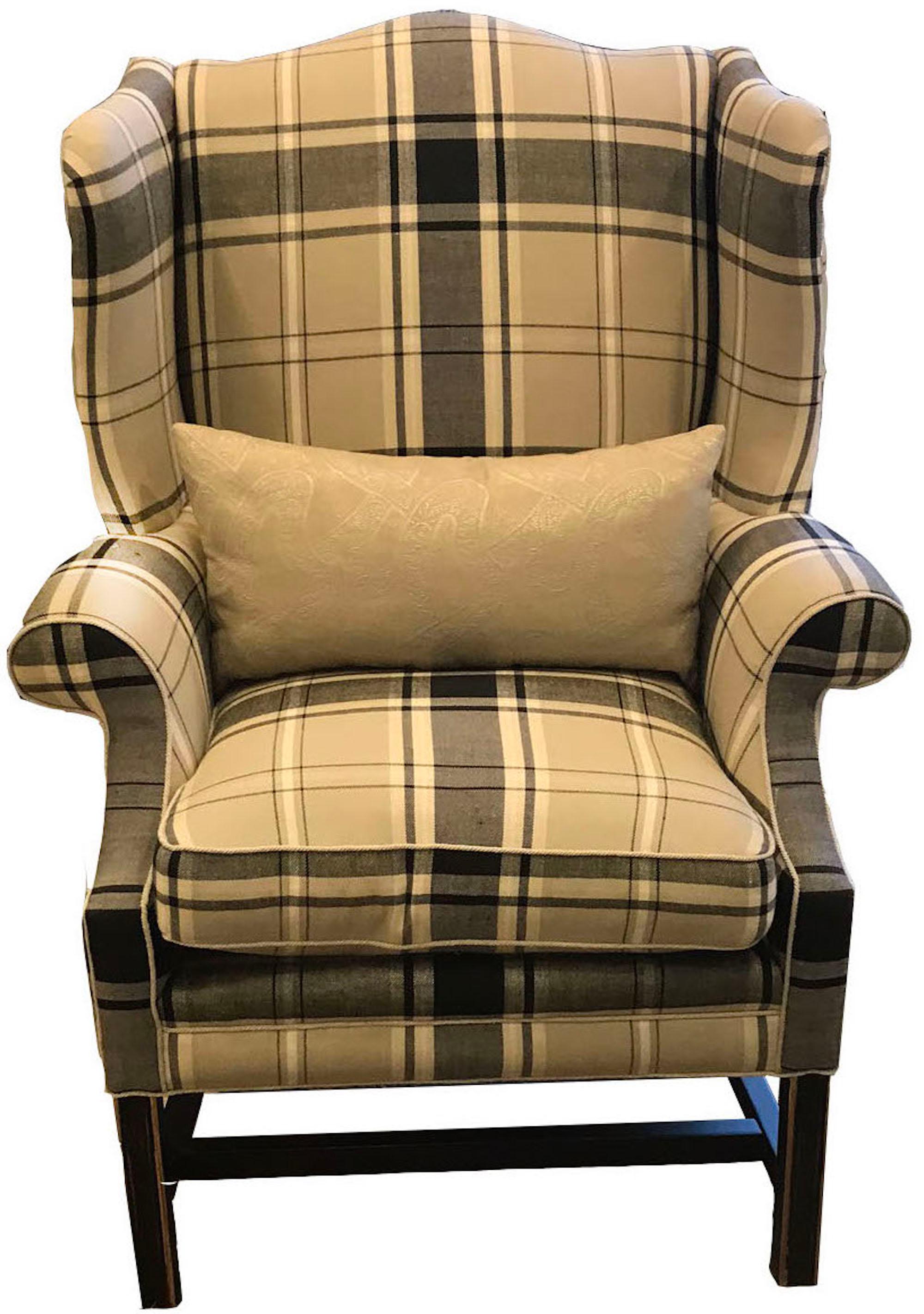 This Hudson wing chair features a maple wood frame that is upholstered in Schumacher's Alexander Tartan fabric in a matte ebony colorway. Atop the frame is a box edge down/feather fill seat cushion with self welt edges and arm rests on either side.