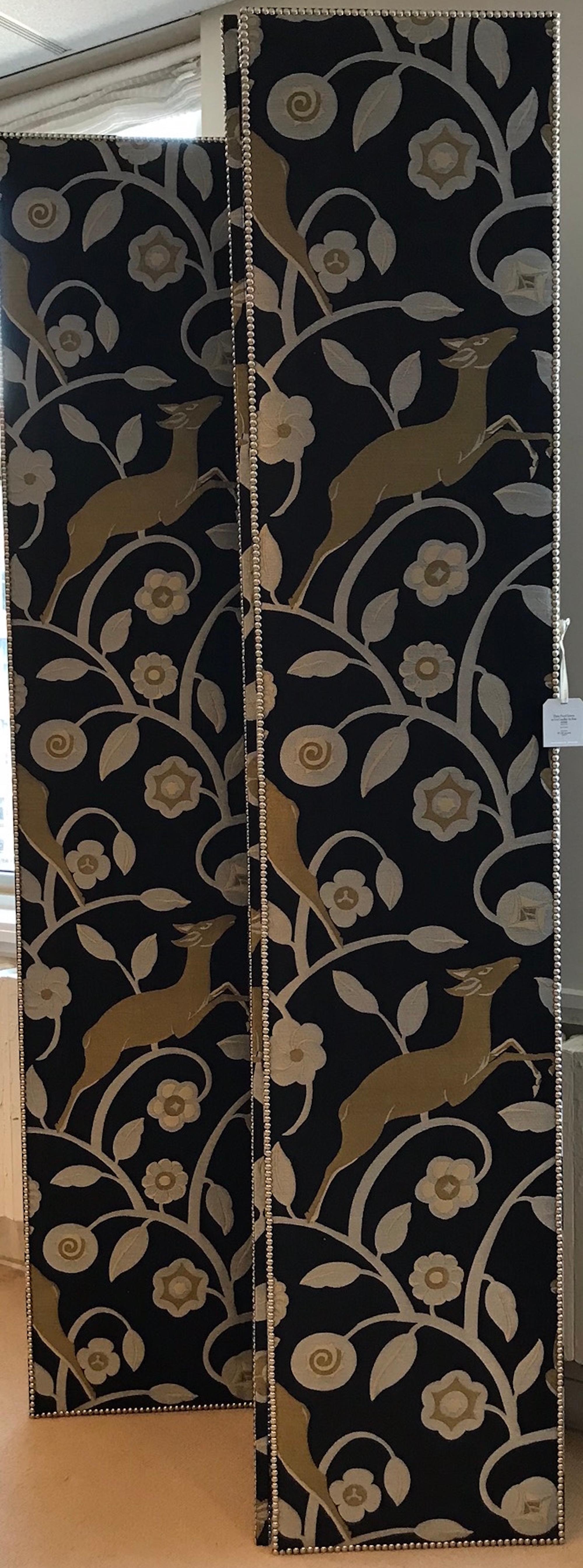 This three panel screen includes a floral and animal design that is colored in gold hues on a black backdrop. The nailhead detailing creates a clean boarder to this elegant accessory and room divider! 

Since Schumacher was founded in 1889, our