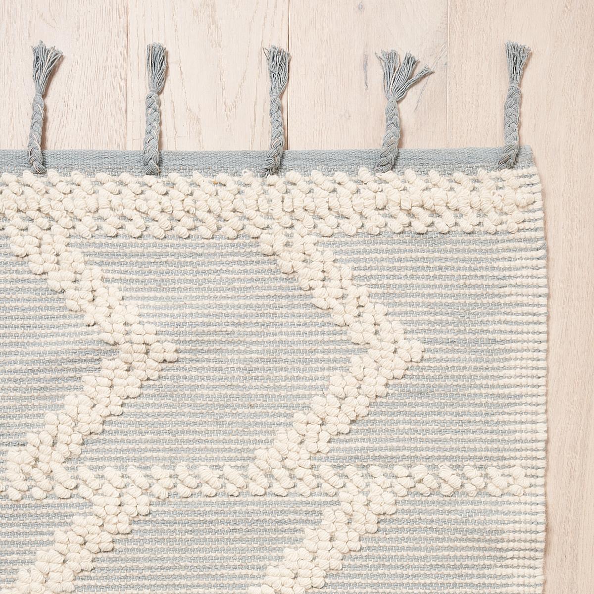 This rug will ship in December. Made of wool and cotton on a traditional pit loom, Malta French Knot is a dynamic stripe with lovely dimension and texture accentuated by tassel fringe. This versatile geometric design has a casual look that works