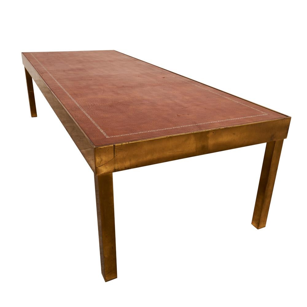 Long and low with a masculine, good looks, this mid-century Belgian coffee table marries a chestnut-colored leather top with an angular brass base. The clean lines and rich patina lend a moment of restrained sophistication that fits in easily in a