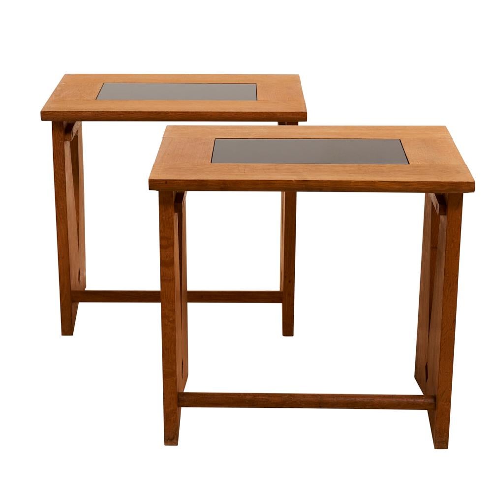 The design team of Robert Guillerme and Jacques Chambron formed Votre Maison in 1949, and by the time Guillerme et Chambron produced this pair of pickled oak side tables in 1960, their aesthetic heavily influenced French design. While the tables are
