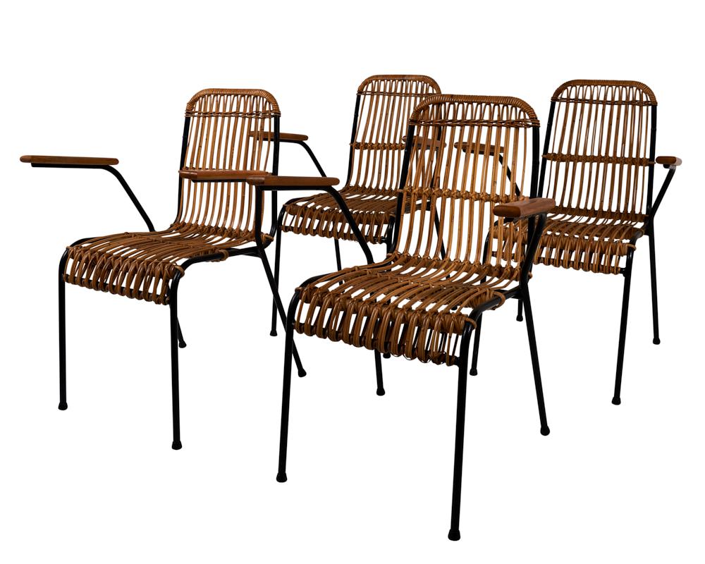 Set of 4 Vintage Rattan Garden Chairs, made in Belgium.  Thanks to the spare lines of the tubular black iron frames, these rattan garden chairs read more modern and contemporary than their all-rattan cousins. Made in Belgium, this versatile set can