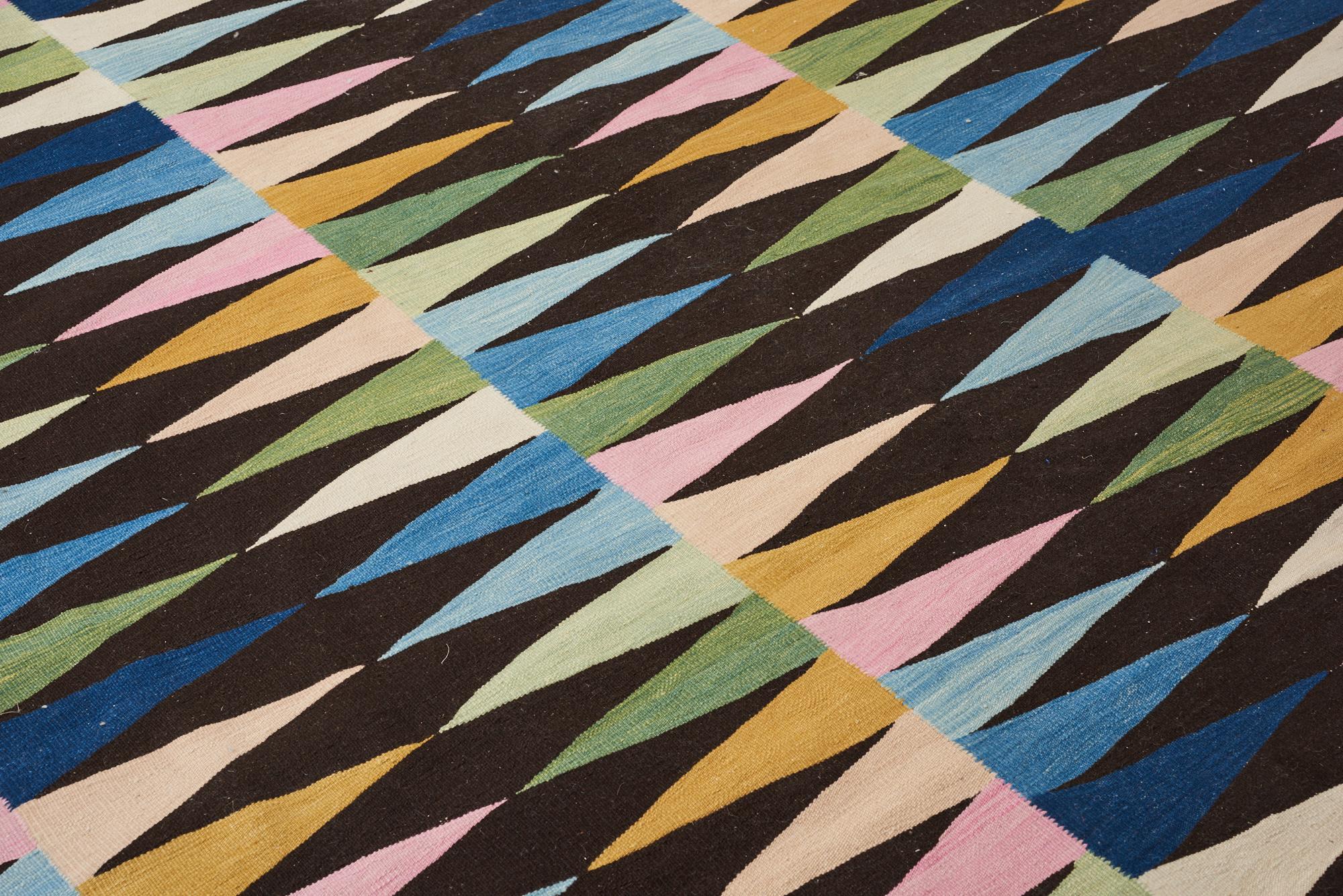 A delightfully fresh take on traditional kilims, the playful En Avant collection celebrates color and pattern. Made of hand spun yarns, these hand knotted and flat-weave rugs include decorative details that evoke embroidery and elements that have a