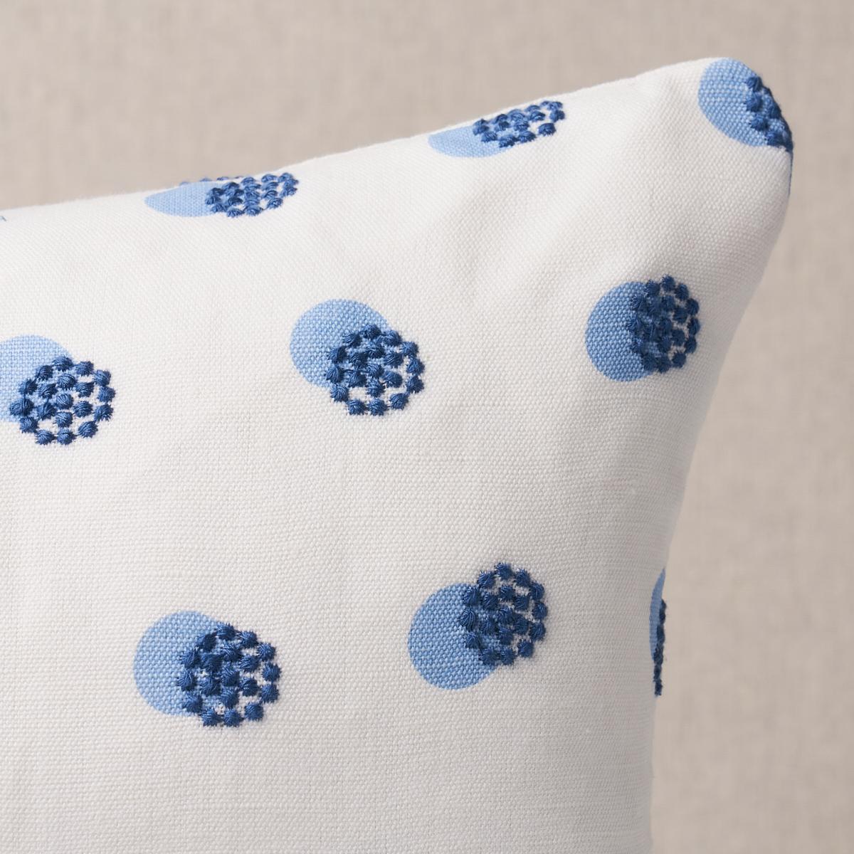 This pillow features Taylor Embroidery with a knife edge finish. Taylor Embroidery in sky-on-navy artfully combines a few simple elements—bursts of offset French knots embroidered over a field of hand-screened dots—for a linen fabric that’s visually