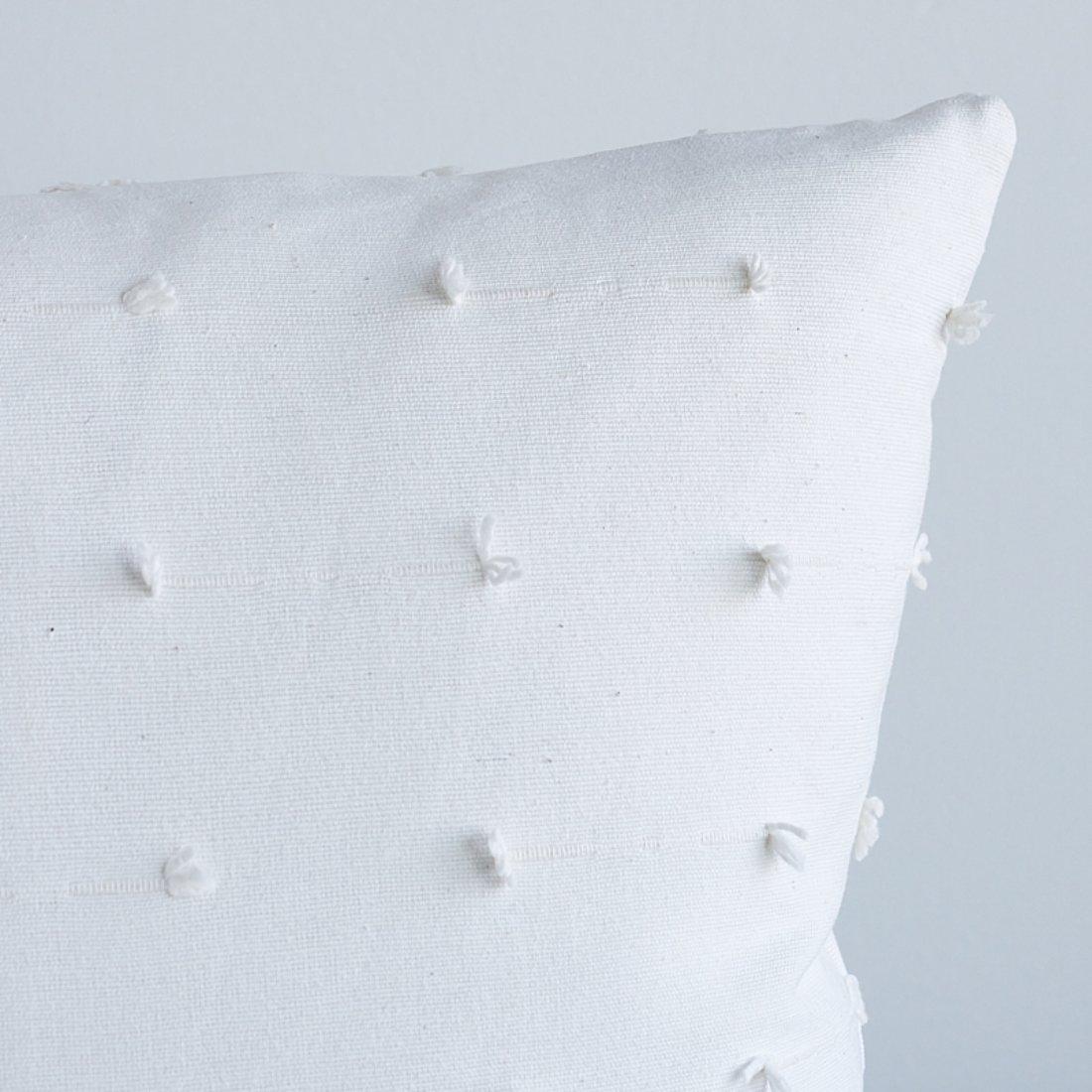 This pillow features Teton with a knife edge finish. Woven in India, Teton is a rustic, all-cotton variation of a fil-coupé with a wonderful handloomed look and charming textural detail. Pillow includes a feather/down fill insert and hidden zipper