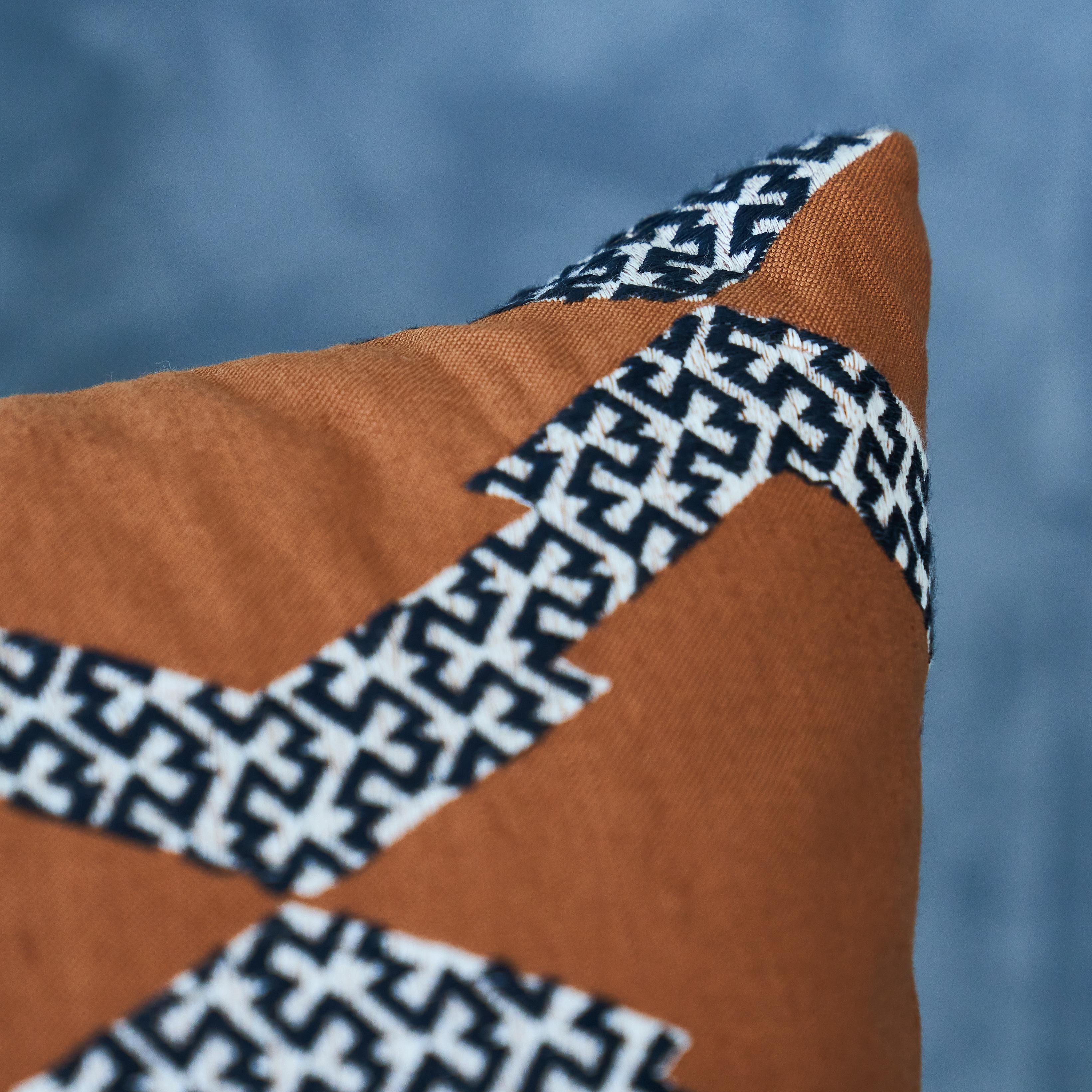 Ce coussin présente un Topi avec une finition en forme de couteau. Combinant deux procédés à forte intensité de main-d'œuvre, l'application√© et la broderie, ce design des plus chics a juste un soupçon d'animal exotique. L'oreiller comprend un
