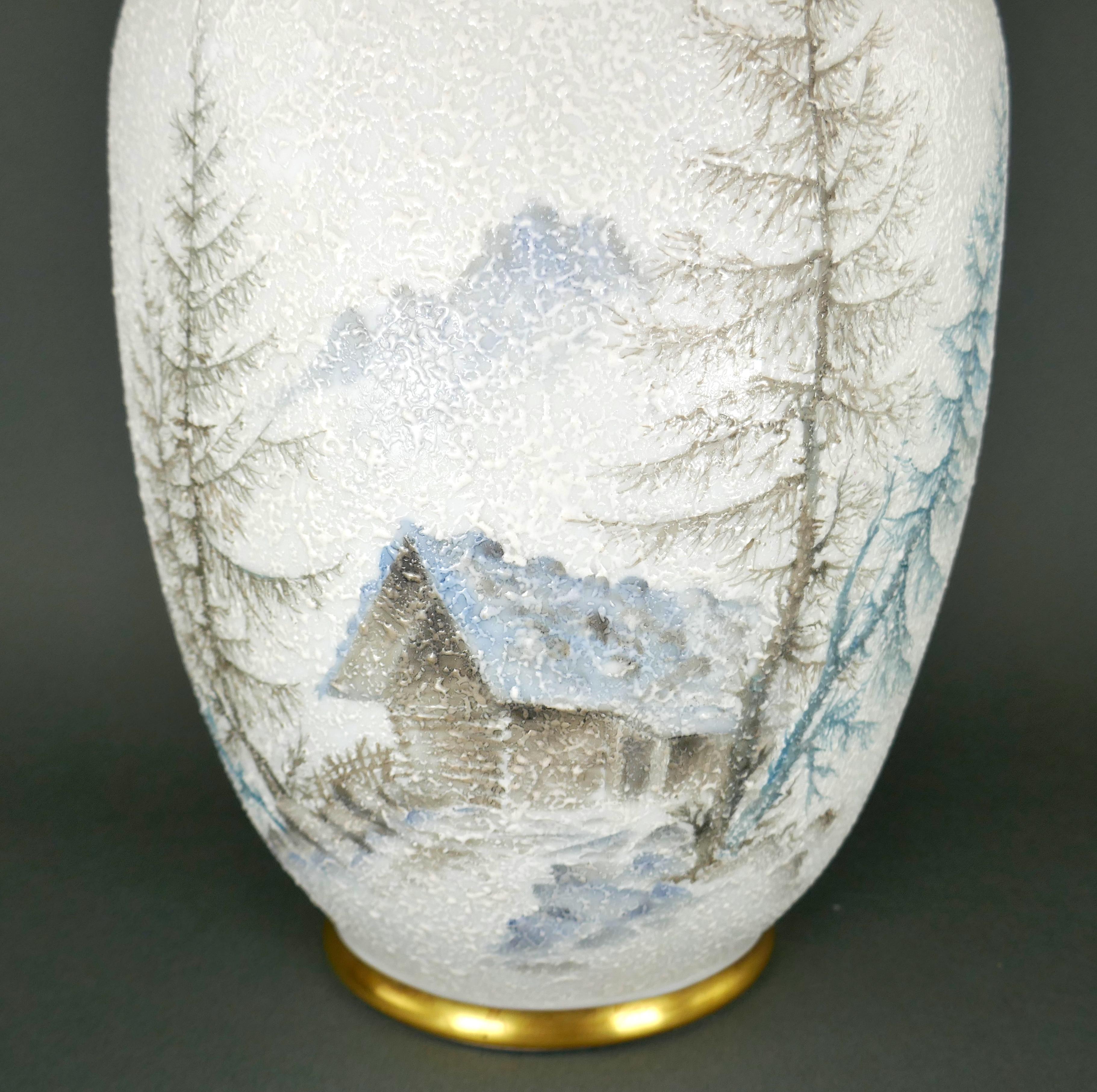 Stunning and sizeable German Porcelain Vase by Schumann Bavaria circa 1950. It features a Moriage raised porcelain texture to create the effect of the scene through falling snow. Features a small cabin built amongst the trees in the German Alps. It