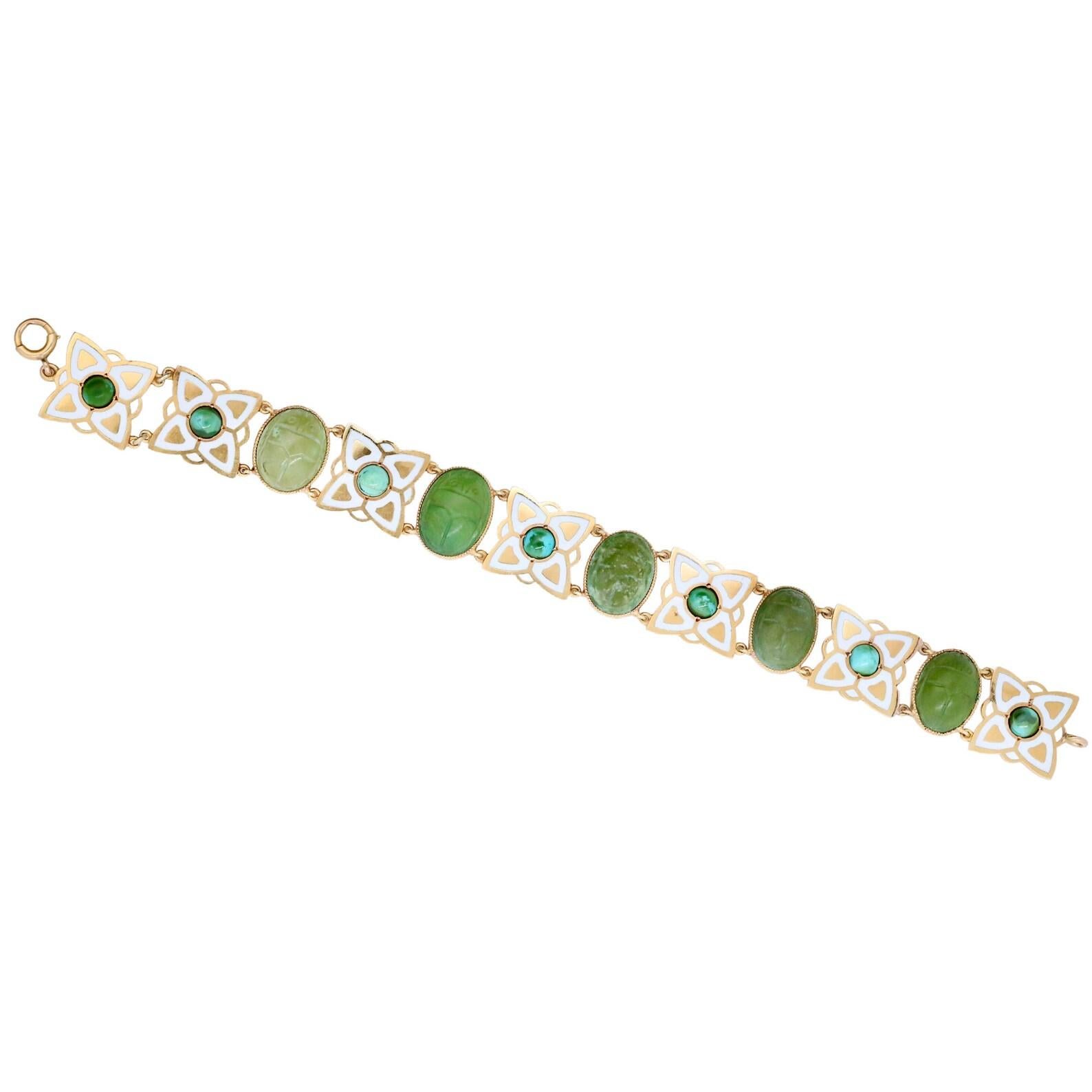 An art nouveau period enameled floral motif bracelet set with ancient scarabs, and cabochons of turquoise. This bracelet features five bezel set green stone ancient scarab jewels. Alternating with the scarabs are beautifully enameled floral motif