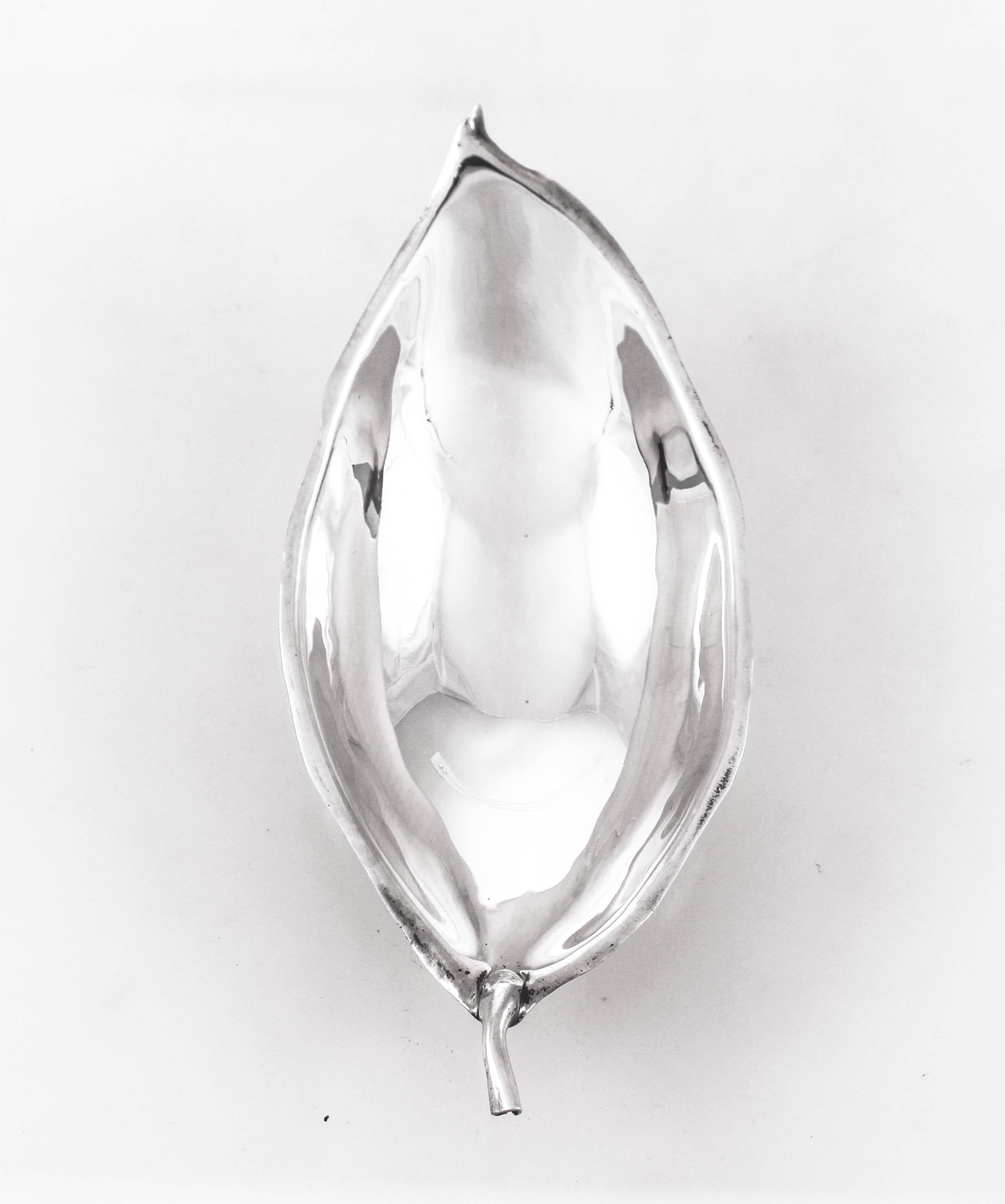 Being offered is a pair of sterling silver handmade leaves by the famous silversmith, Alfredo Sciarrotta. Sciarrotta's work is characterized by a sleek and simple style, and many of his smaller pieces feature his signature leaf-shape designs. During