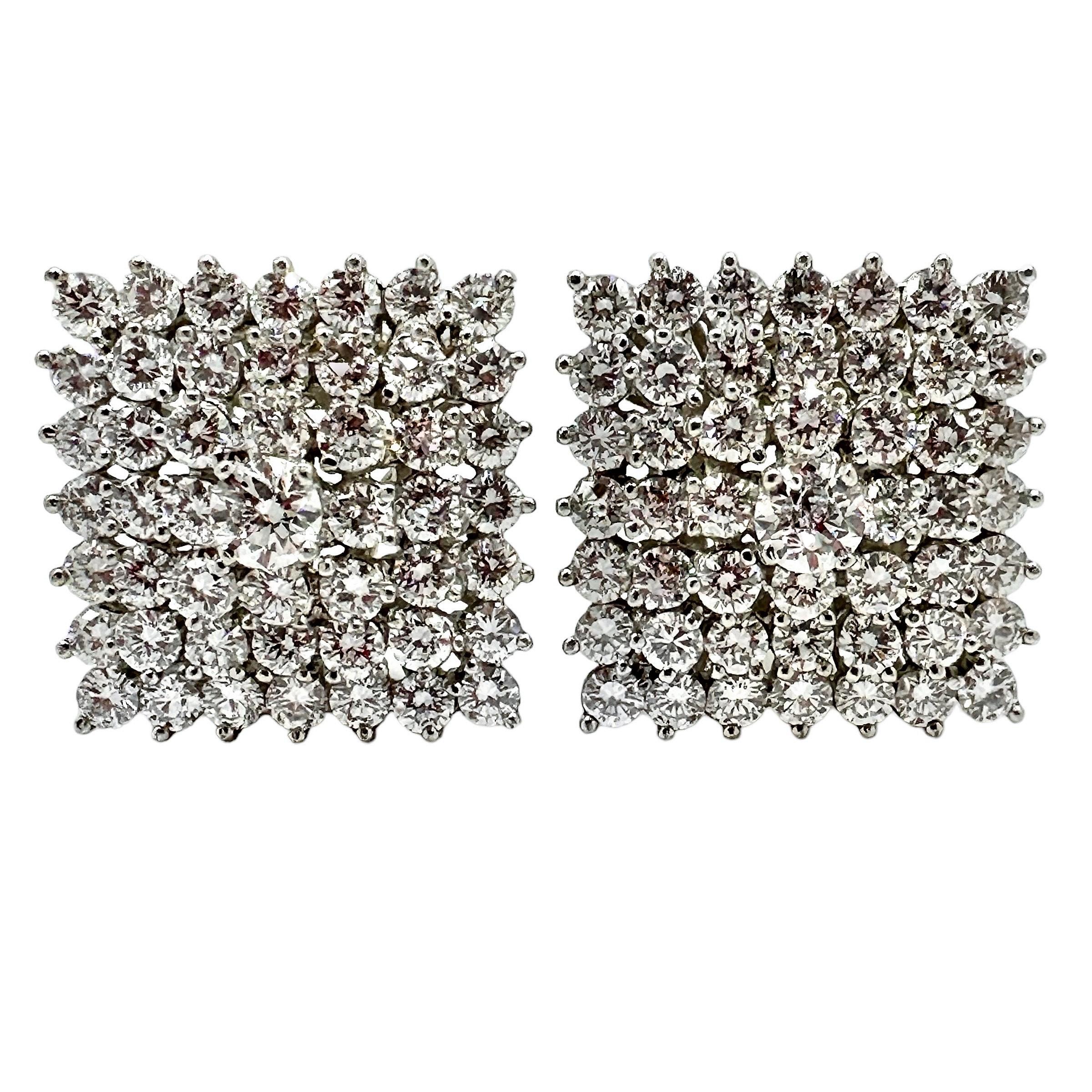 This seductive pair of vintage platinum Tiffany earrings are set with a total of 98 brilliant cut diamonds with a center stone in each weighing approximately .35ct. The pair scintillates beautifully. Total approximate diamond weight is 8.75ct of