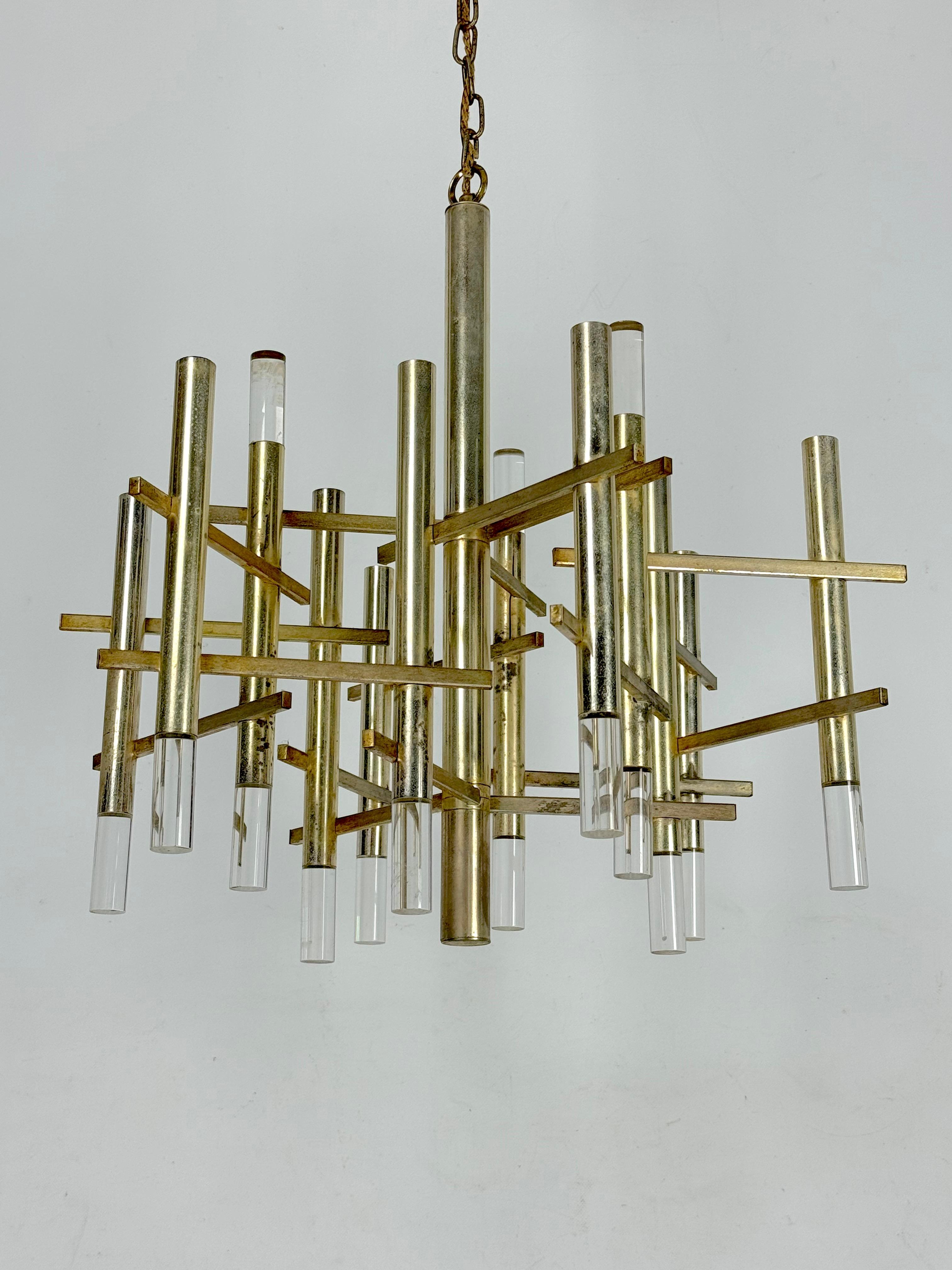 Produit en Italie dans les années 60 par Sciolari, il est en bon état avec des traces d'âge et d'utilisation. Fabriqué en chrome doré et en plexiglas, il comporte 9 douilles pour ampoules E14. Hauteur du luminaire sans tige 60 cm. Fonctionne