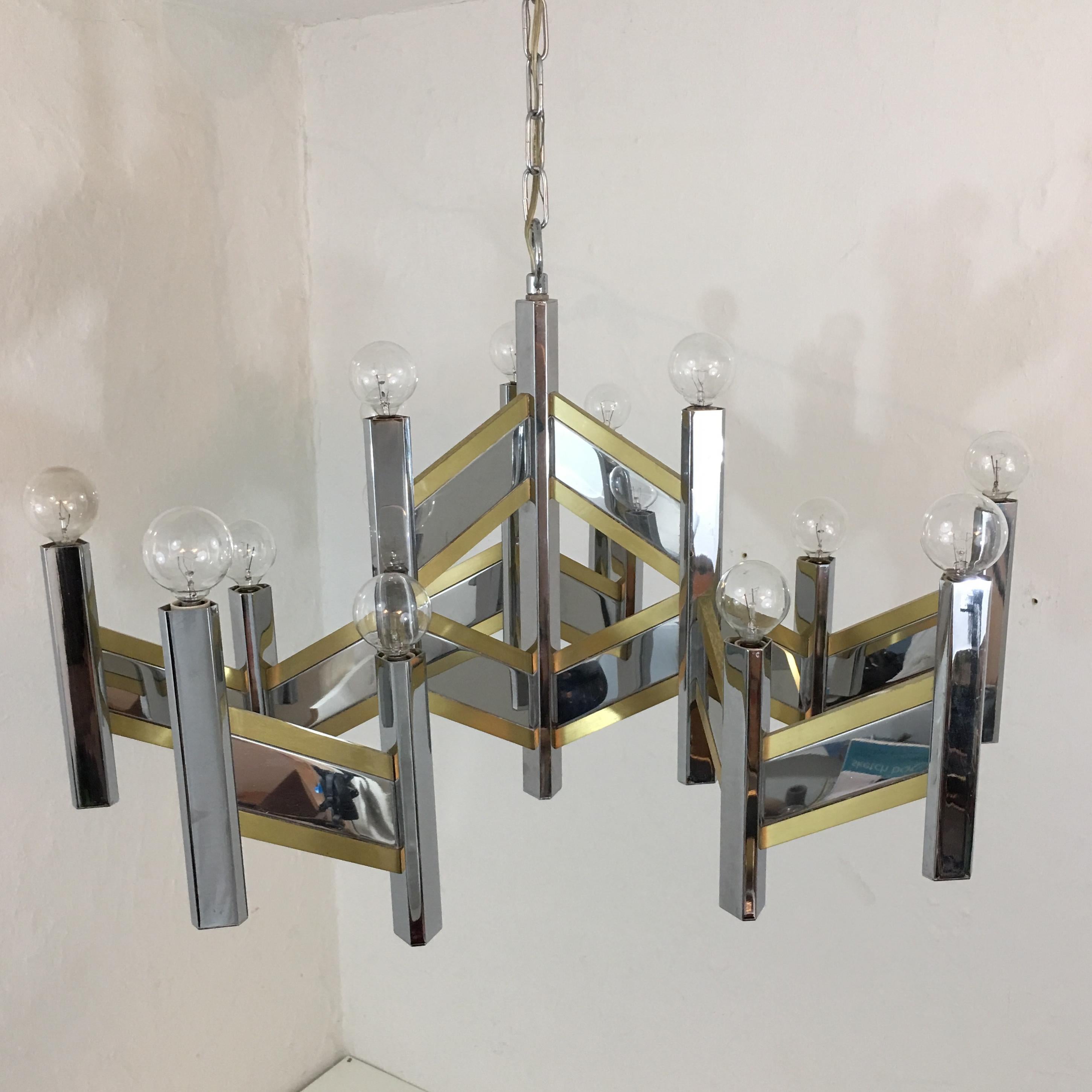  Gaetano Sciolari brass and chrome 15 bulb chandelier. The mirror like quality of the chrome and the subtle brass make this an outstanding piece. Modern yet classic with a touch of mid century. The chandelier measures 29 inches across arm to arm and