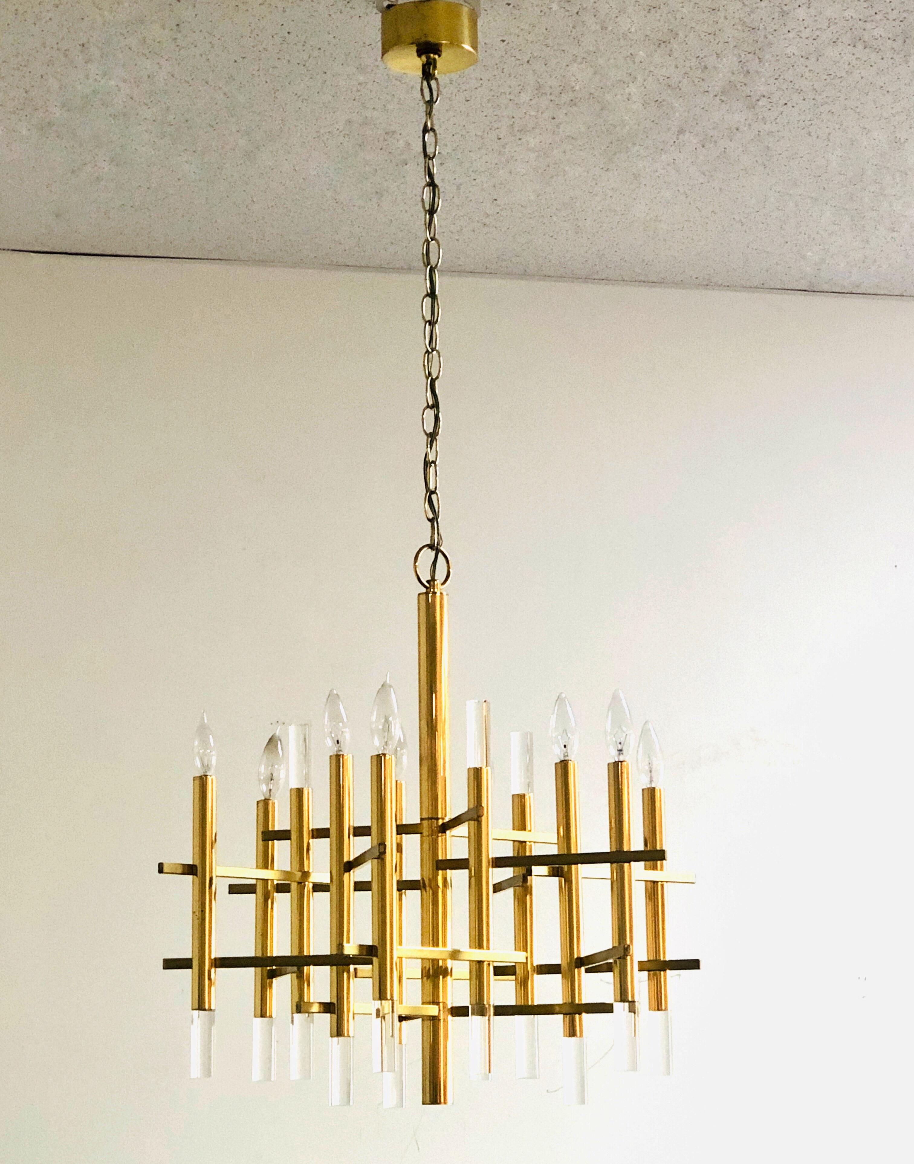 Iconic chandelier by Sciolari. Polished brass and Lucite. Takes 9 chandelier bulbs. 50