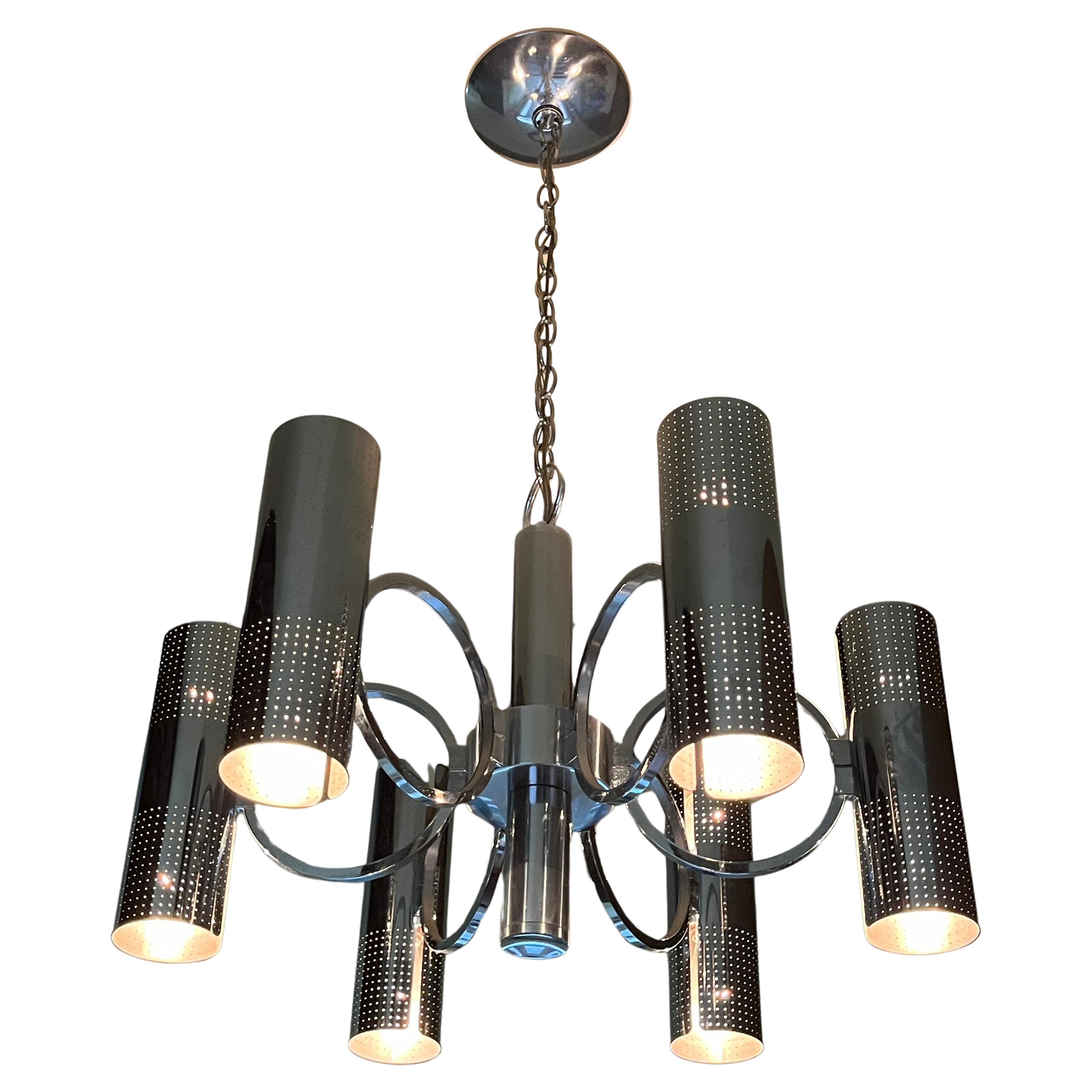 Beautiful eight art chandelier with canister light fixtures extending from circular arms. Each canister has pinhole perforations creating a dramatic experience. Lights face up and down. Chrome in excellent vintage condition. 