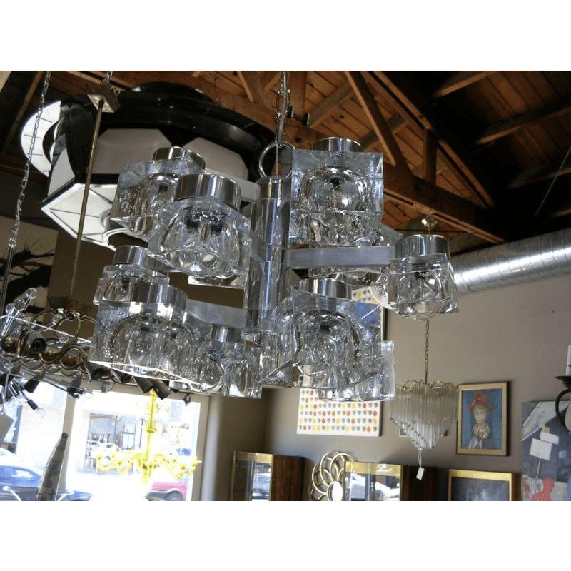 A Gaetano Sciolari designed 12 light chandelier, made for Lightolier, in three levels of four arms and cubes. Lower and upper levels are the same size. The middle section cubes are slightly smaller.