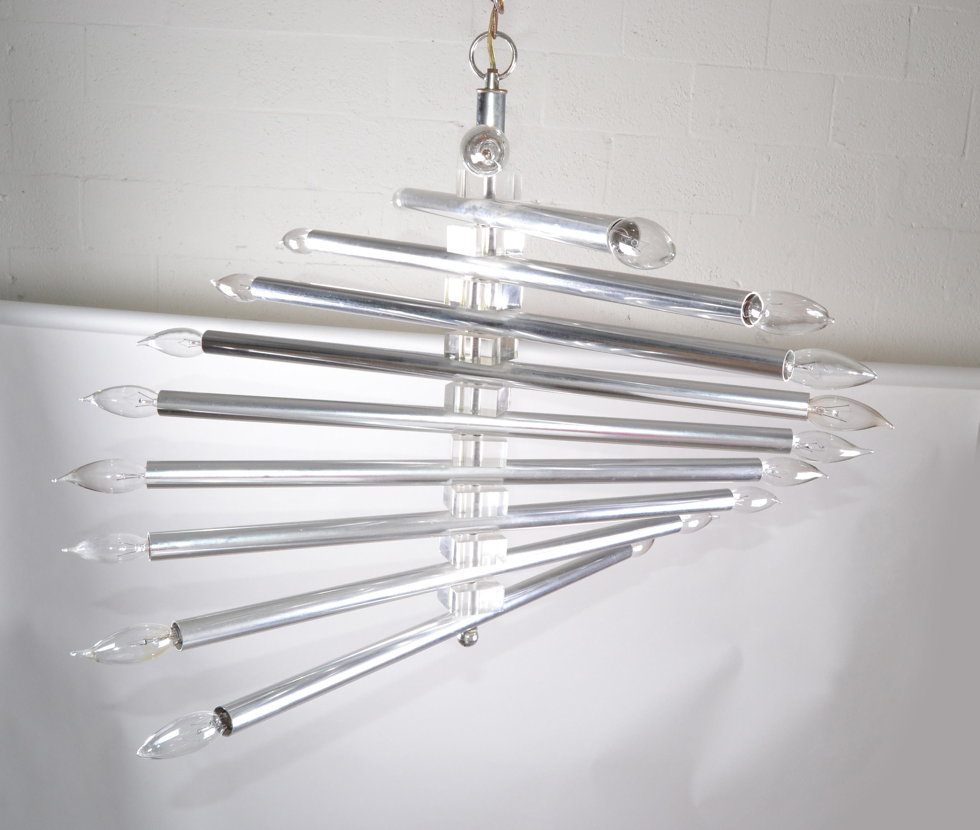 Italian Mid-Century Modern Gaetano Sciolari chrome and Lucite twenty-light chandelier from the 1970s.
Comes with a 17 inches long chain and canopy.
US rewired and in working condition and takes 24 light bulbs with max 25 watts per bulb.