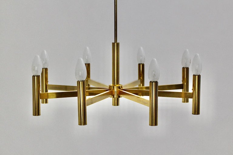 A Gaetano Sciolari vintage golden metal Mid-Century Modern chandelier, which was designed, 1960s, Italy.
Gaetano Sciolari came from a family, who designed and manufactured lightings. He was famed for lightings in futuristic and sculptural metal