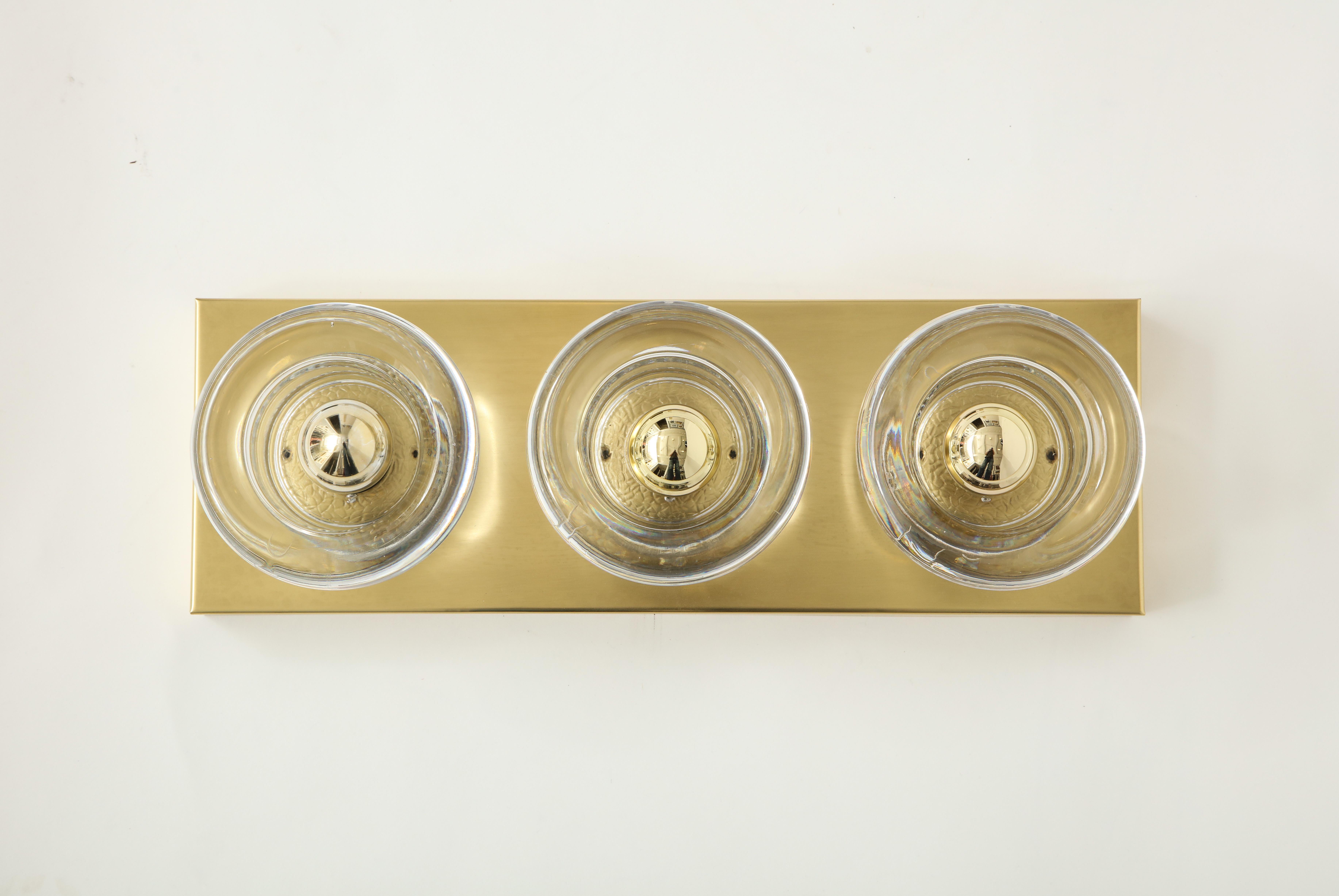 Pair of rectangular form brushed brass sconces, each with 3 heavy molded glass surrounds. Rewired for use in the USA.