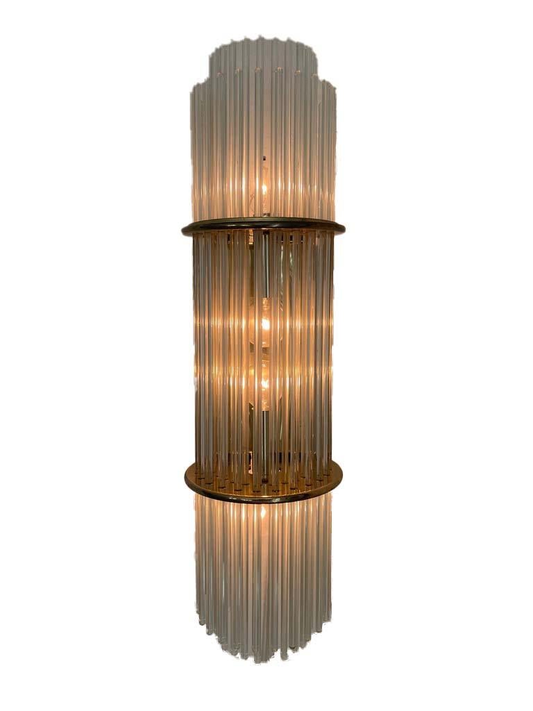 Glass-rod and brass wall-mount sconce in the style of Sciolari. Glass rods are clear. Rods from the  back of fixture are missing--this is not visible when mounted. This light would be gorgeous as a featured light on a smaller wall or in a bathroom.