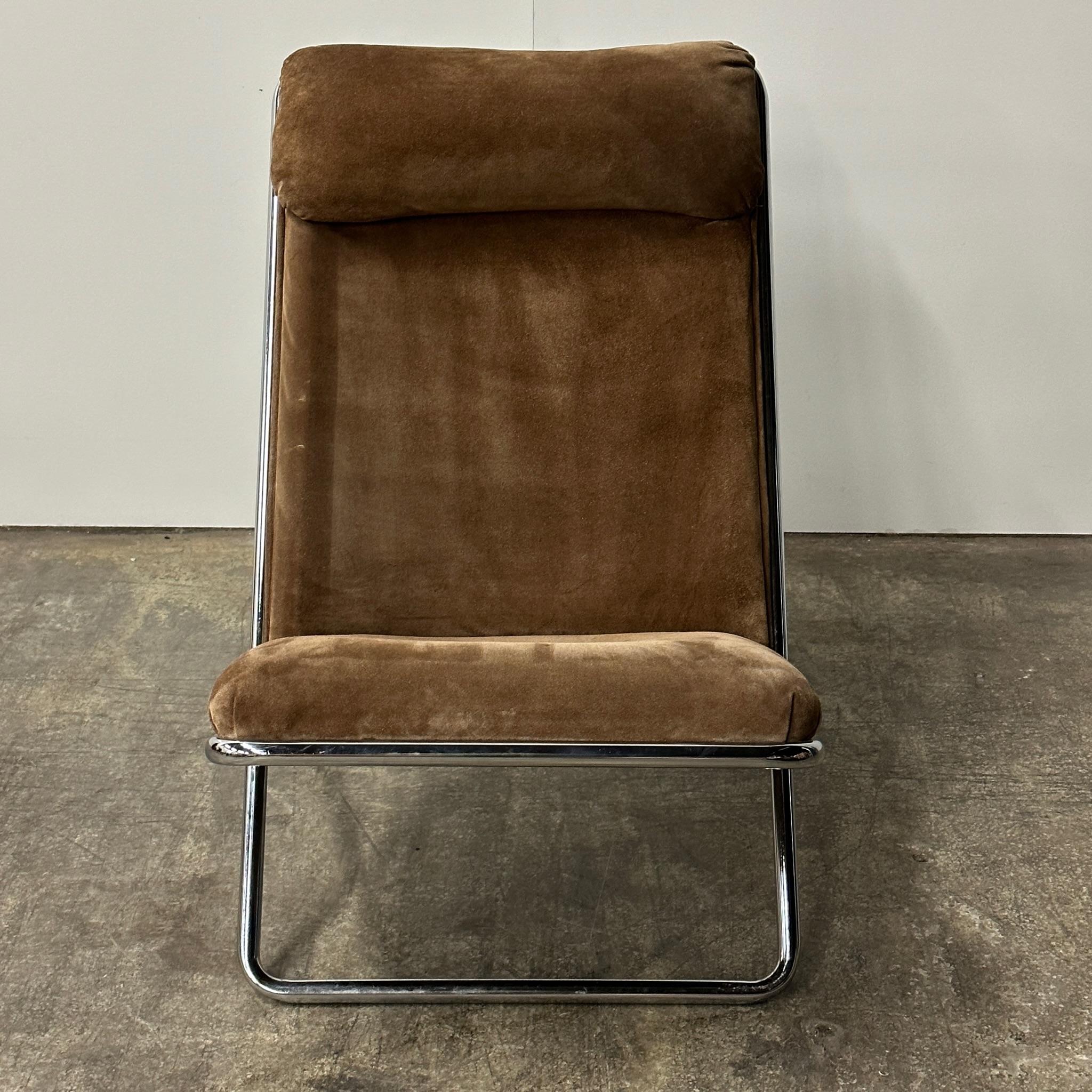Upholstered in original brown suede. A rare piece to find in the original upholstery.