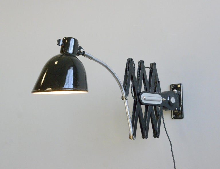 Scissor lamp by Schaco Circa 1930s

- Extendable scissor mechanism
- Curved chrome arm
- Vitreous black enamel shade
- Original On/Off toggle switch on the shade
- Takes E27 fitting bulbs
- Produced by Schanzenbach & Co, Frankfurt
- German ~