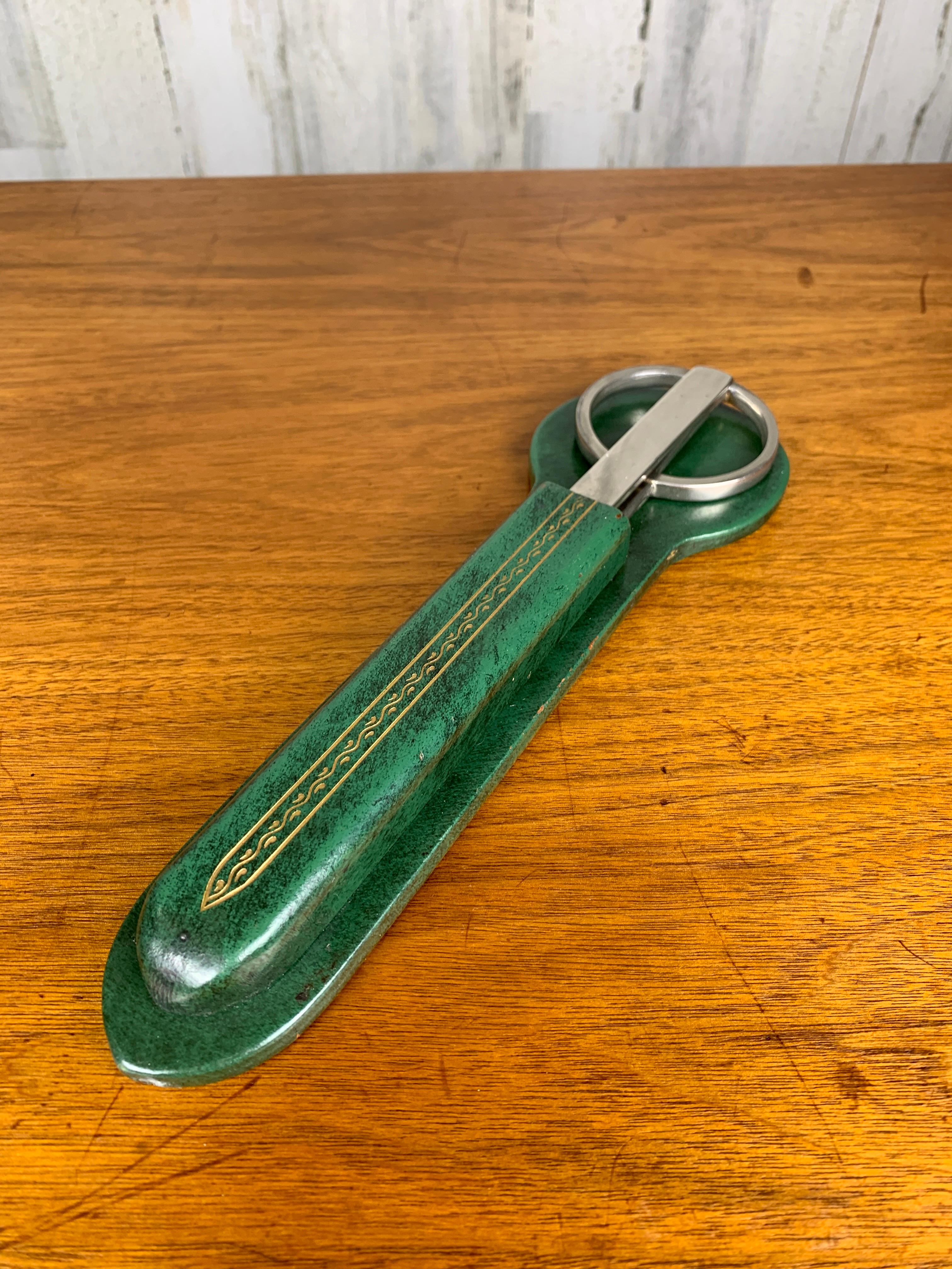 Gold leaf design on bankers green leather holder with nickel plated letter opener and D shaped handle forged scissors.
